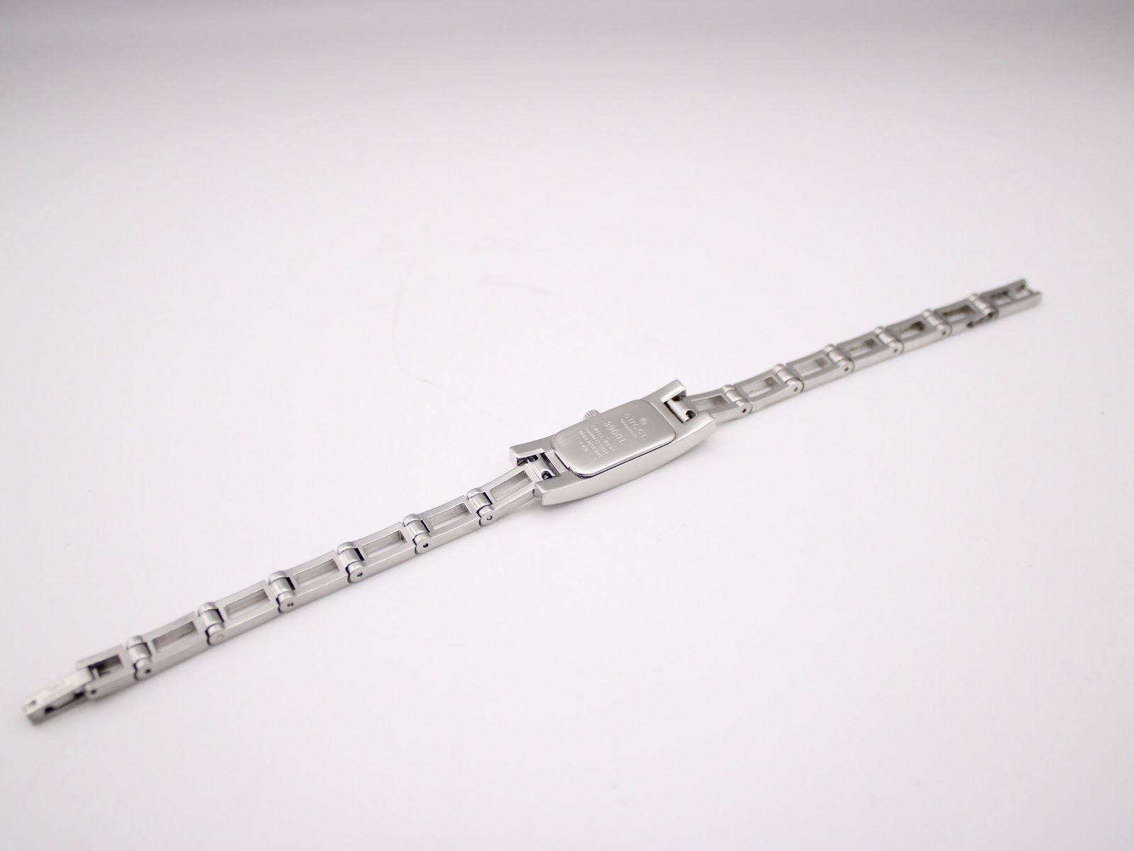 Rear view of the Gucci 3900L watch, showing the case back and the full length of the extended stainless steel bracelet.