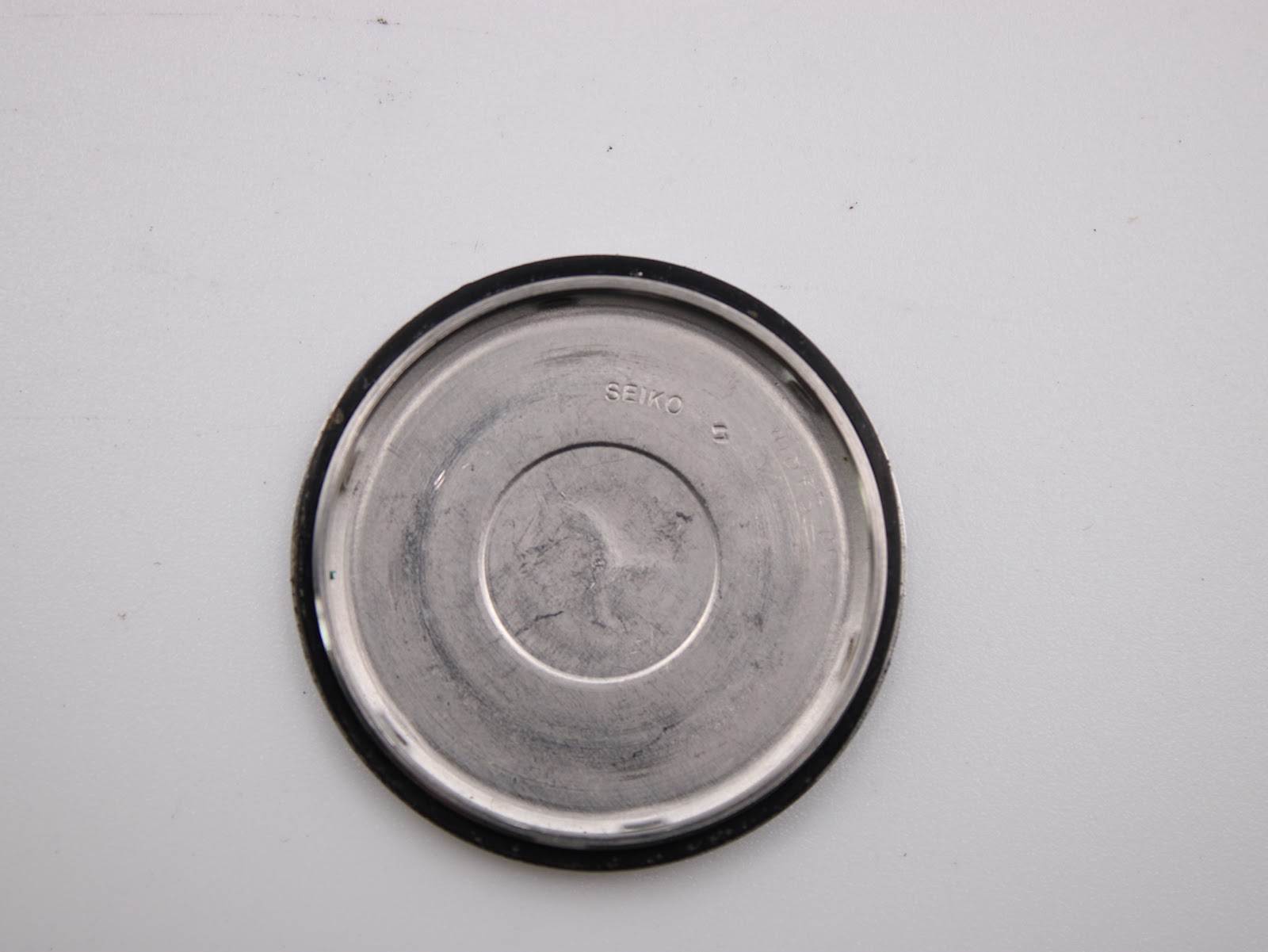 Interior view of the stainless steel case back, showing the polished finish.