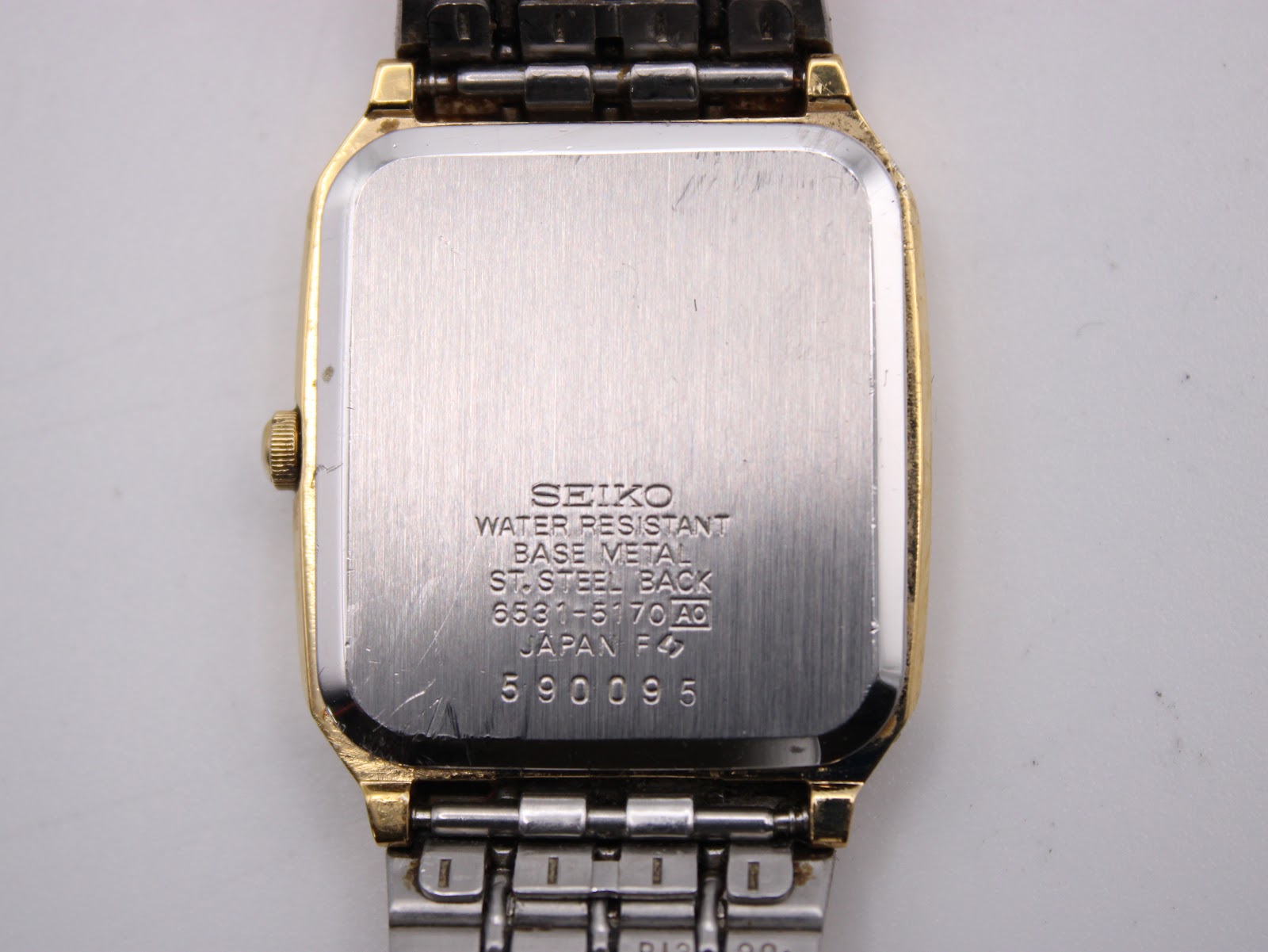 Close-up of the stainless steel case back showing Seiko engravings and model number 6531-5170 and serial number 590095.