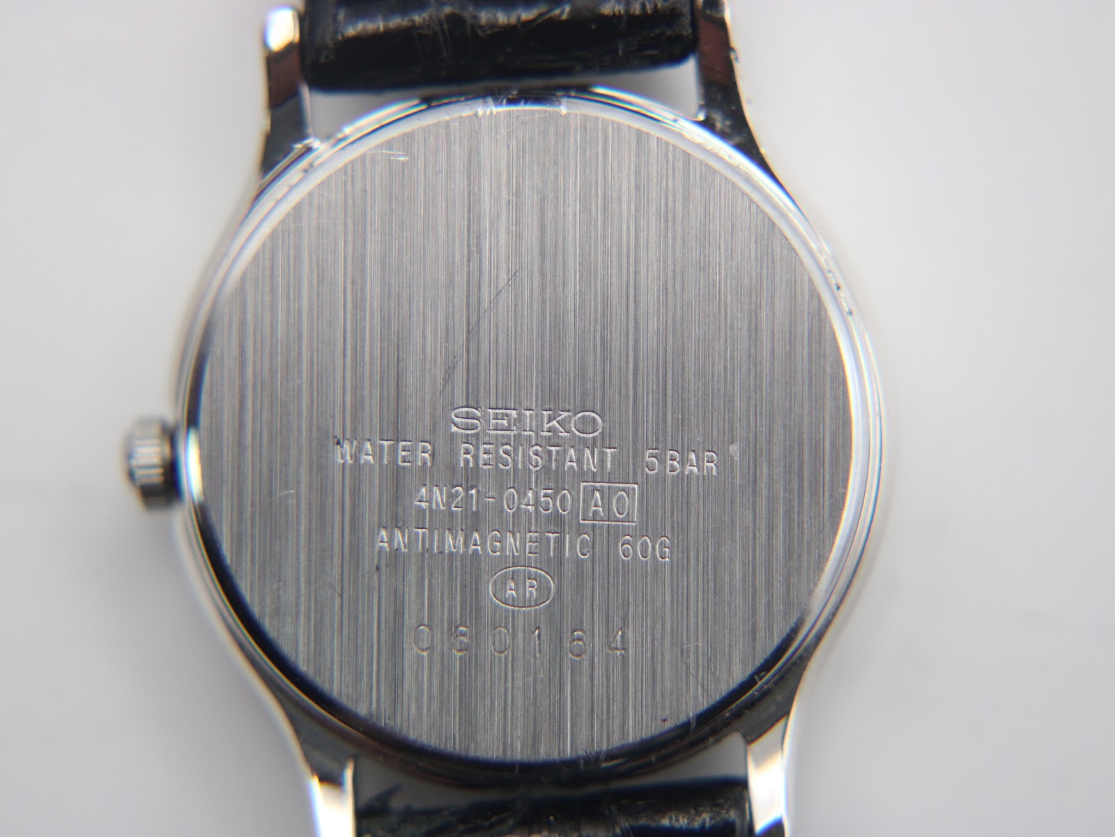 Another angled side view of the Seiko Spirit watch, displaying the watch's elegant curve and strap.