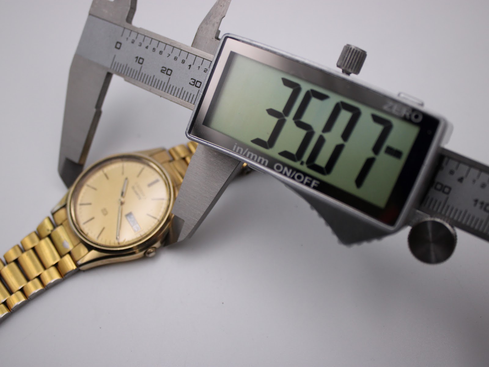 Digital caliper measuring the case diameter of the Seiko watch, showing 35.07mm.