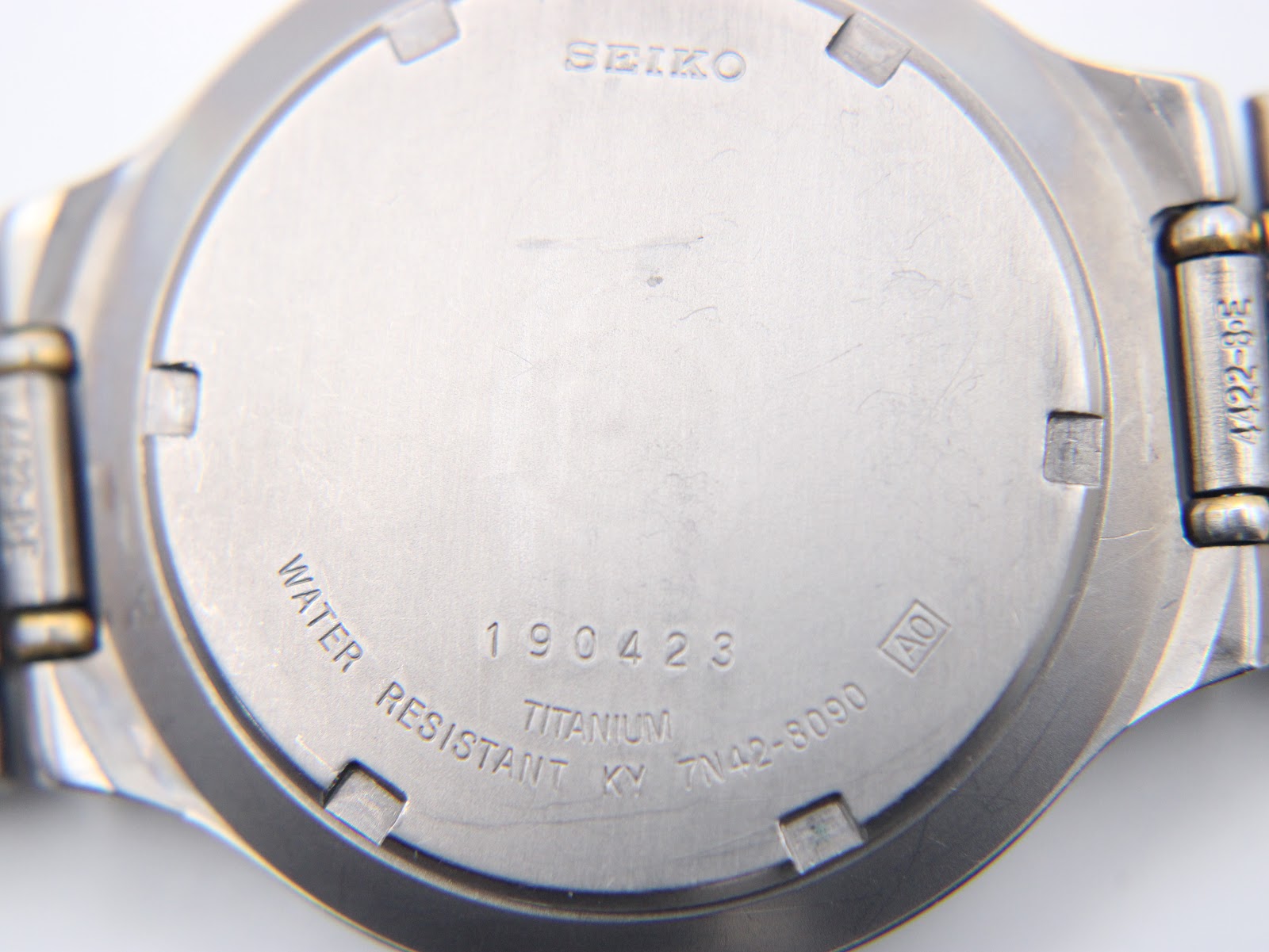 Close-up of the Seiko titanium case back showing model number 7N42-8090 and serial number 190423.