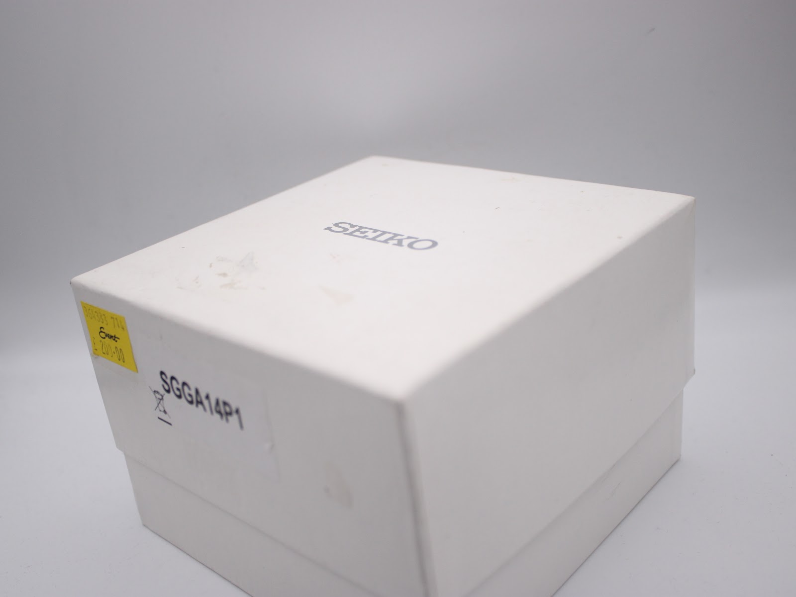 White Seiko watch box with 'SGGA14P1' sticker, possibly a retail or model reference.