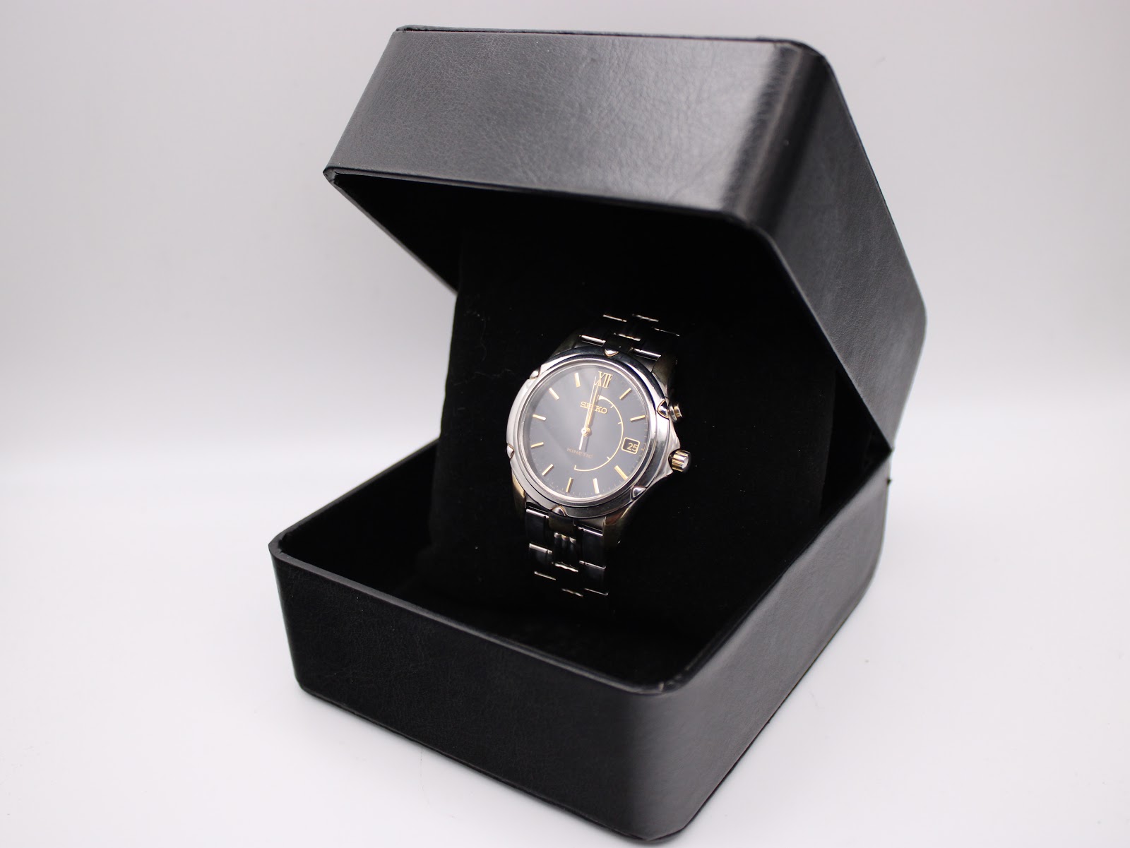 The Seiko Kinetic watch nestled within a black presentation box with a velvet interior.