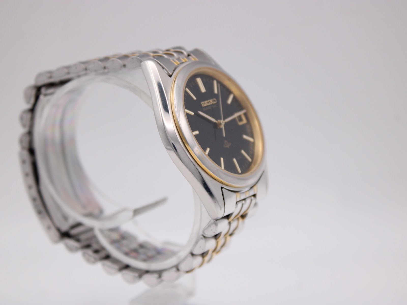 Another angled view of the Seiko watch, highlighting the case shape and the two-tone stainless steel bracelet.
