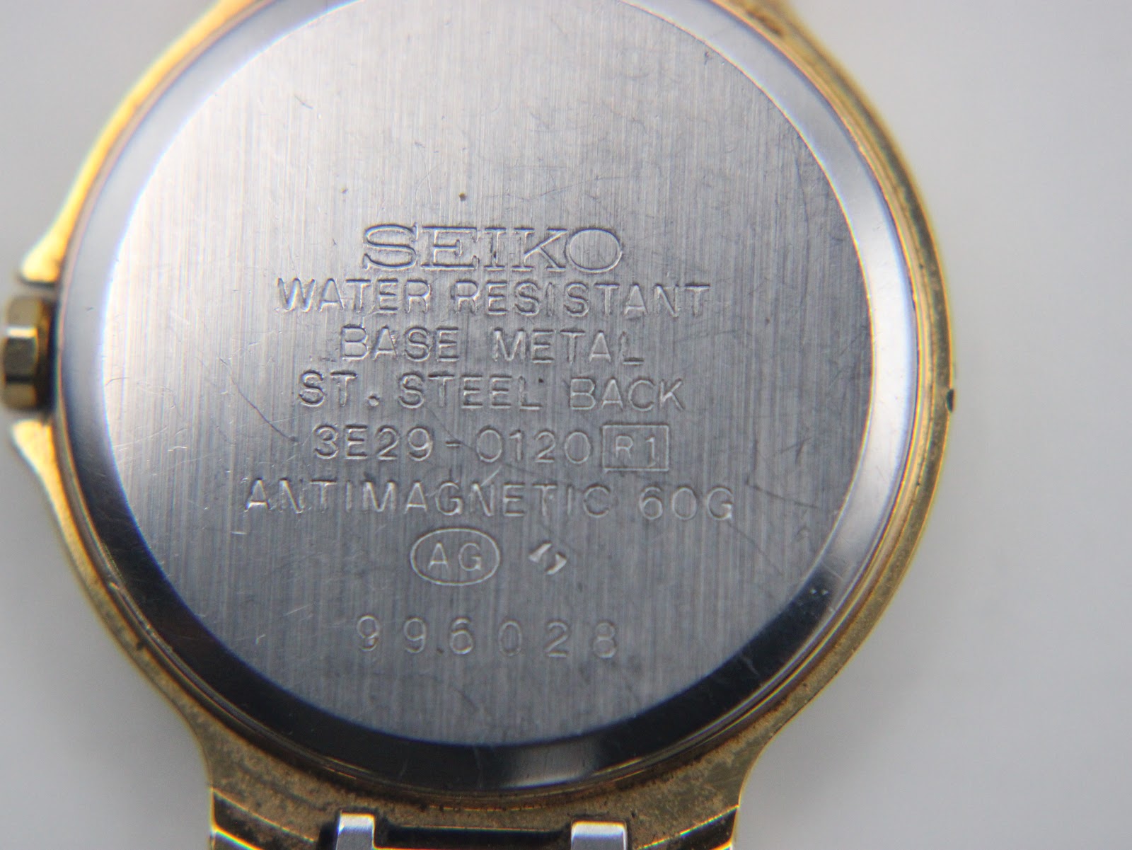 Close-up of the stainless steel case back with Seiko branding and model number 3E29-0120 engraving.