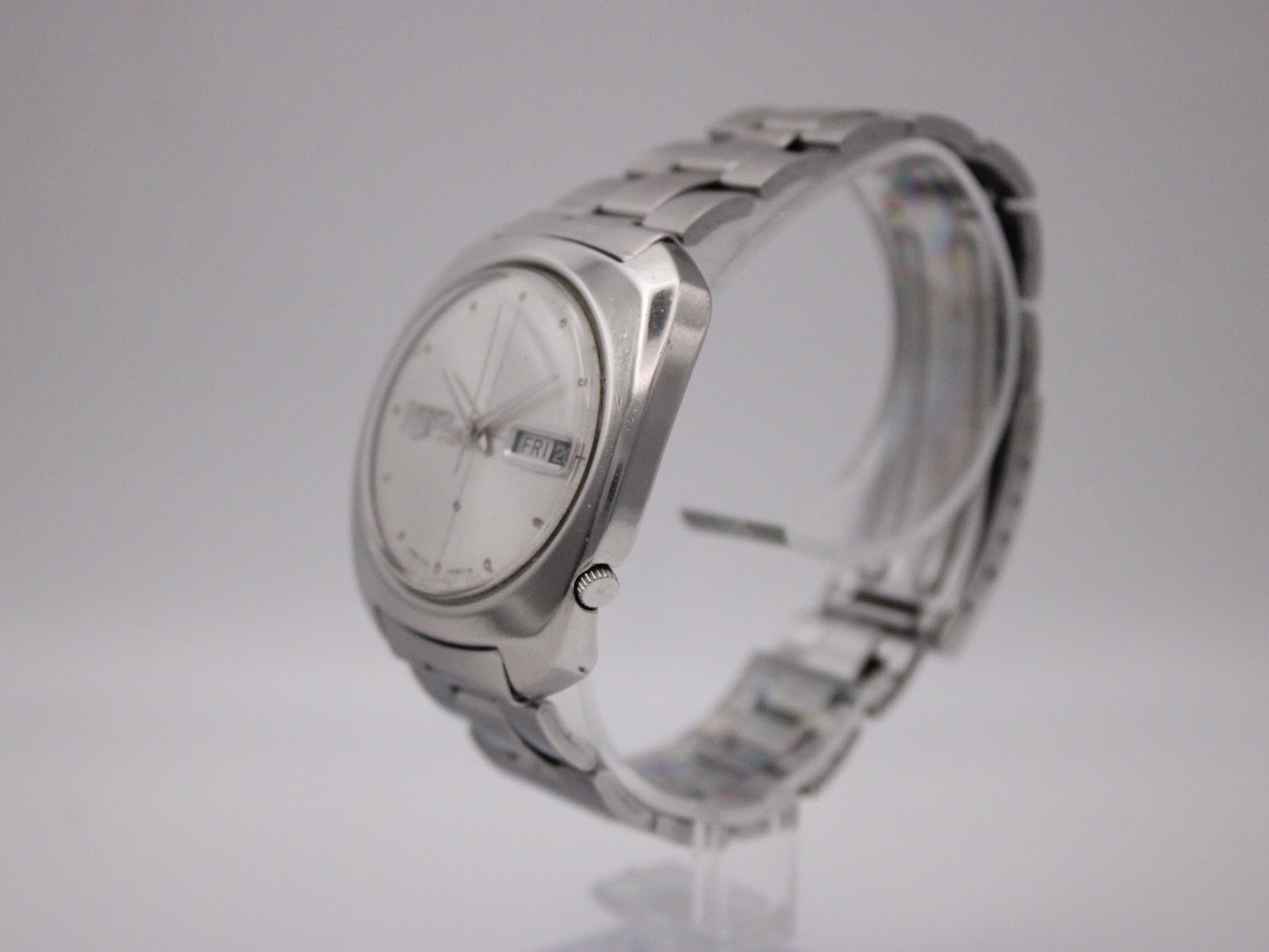Angled side view of the Seiko 6119-7080 watch, showing the brushed and polished stainless steel case and bracelet.