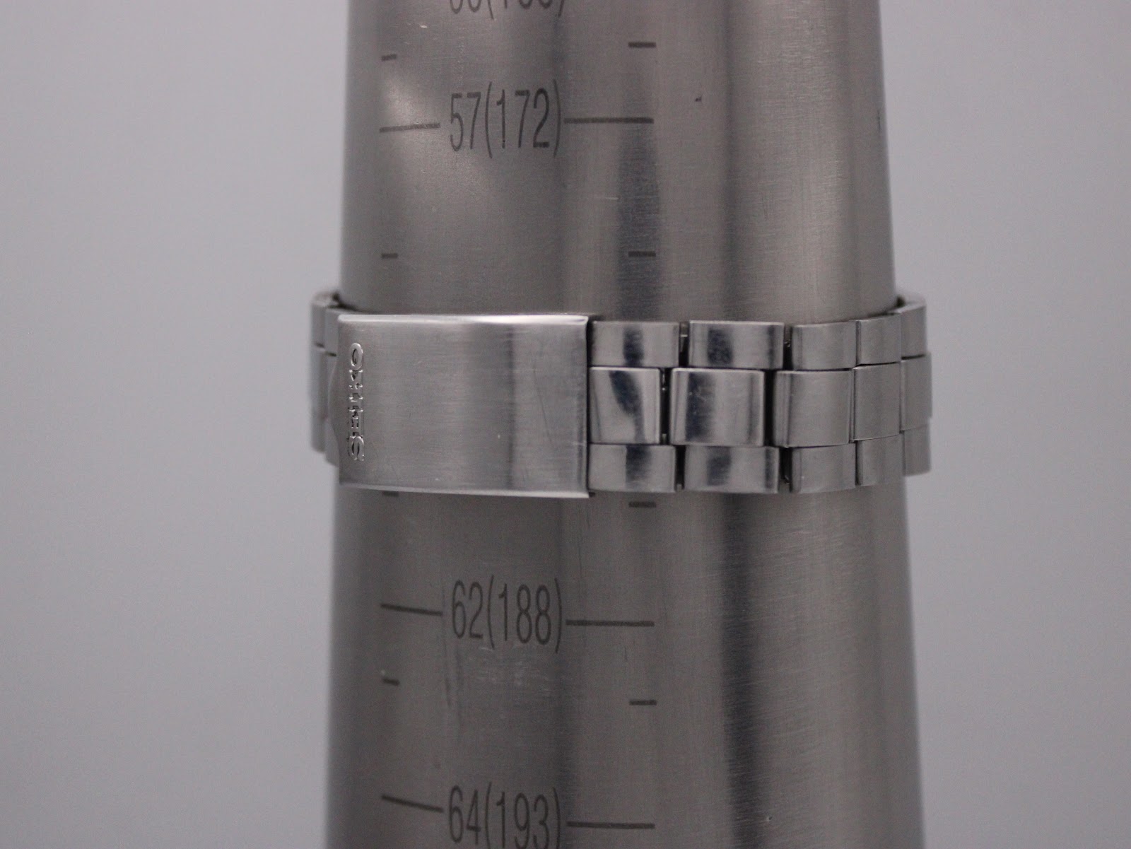 The watch bracelet wrapped around a wrist sizing gauge, showing a circumference measurement of approximately 188mm / 18.8cm.