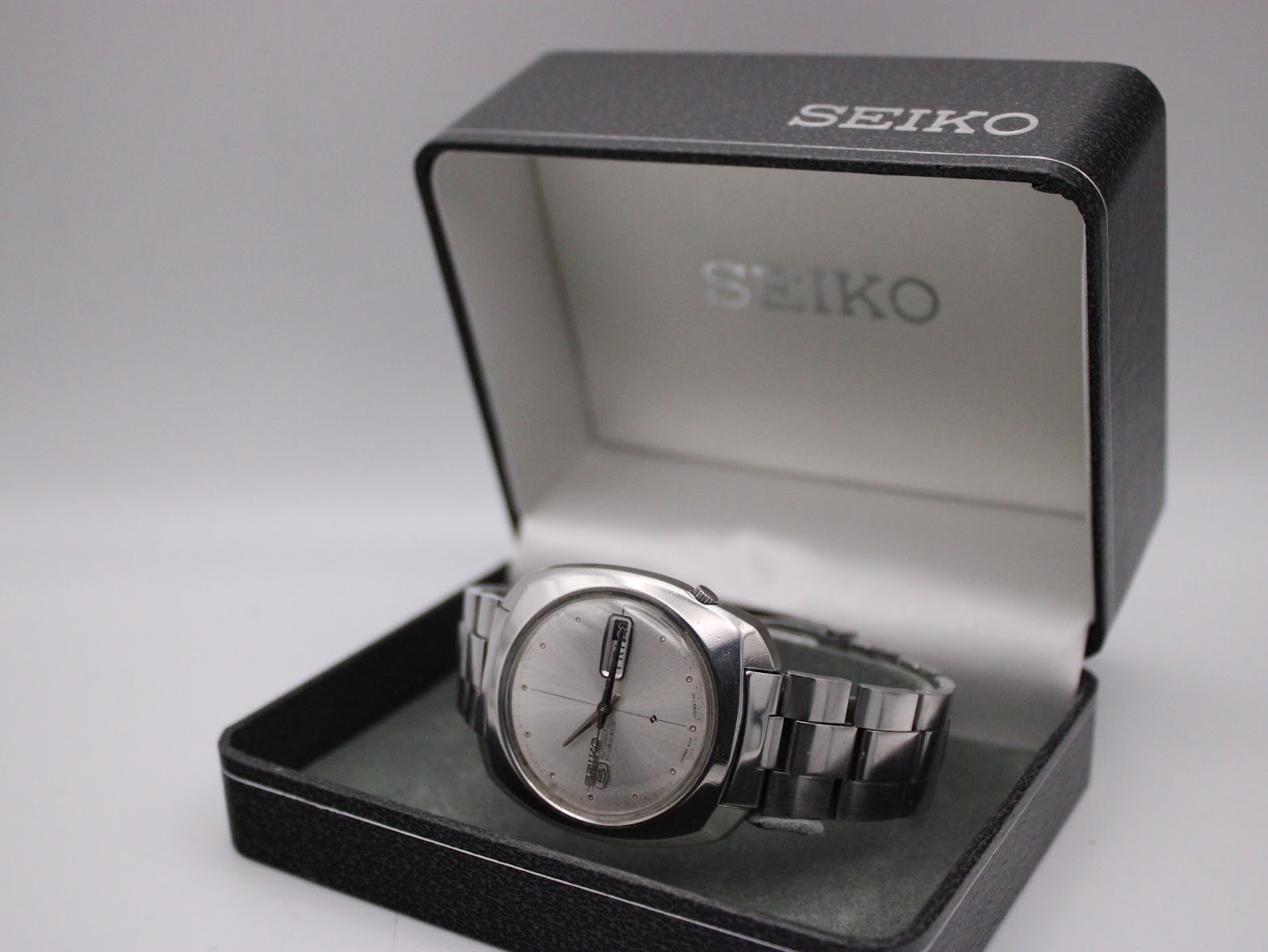 The Seiko 6119-7080 watch resting in its original black Seiko presentation box.