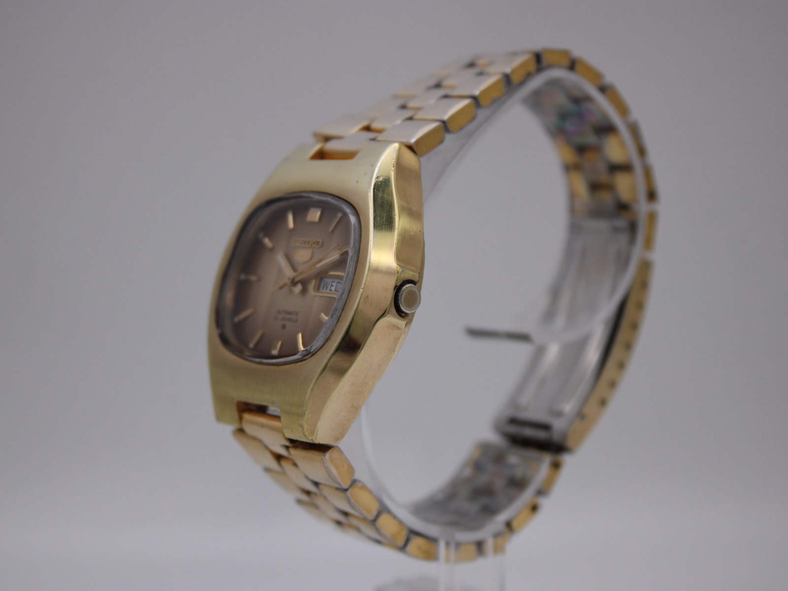 Side profile of the Seiko watch, showing the cushion case and integrated bracelet.