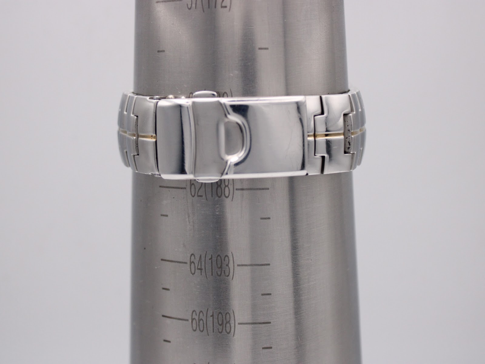 Two-tone stainless steel bracelet displayed on a wrist sizing cone, indicating a wrist size of approximately 188mm.