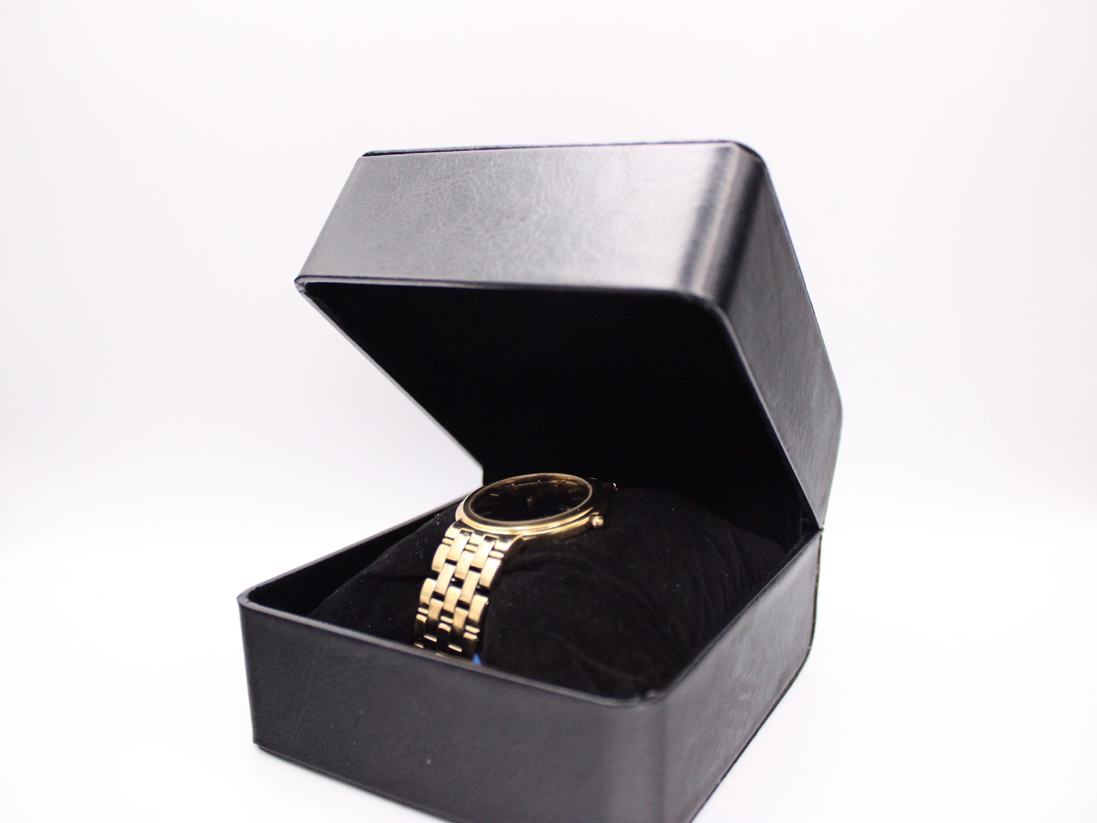 The vintage Seiko watch displayed inside an open black watch box.