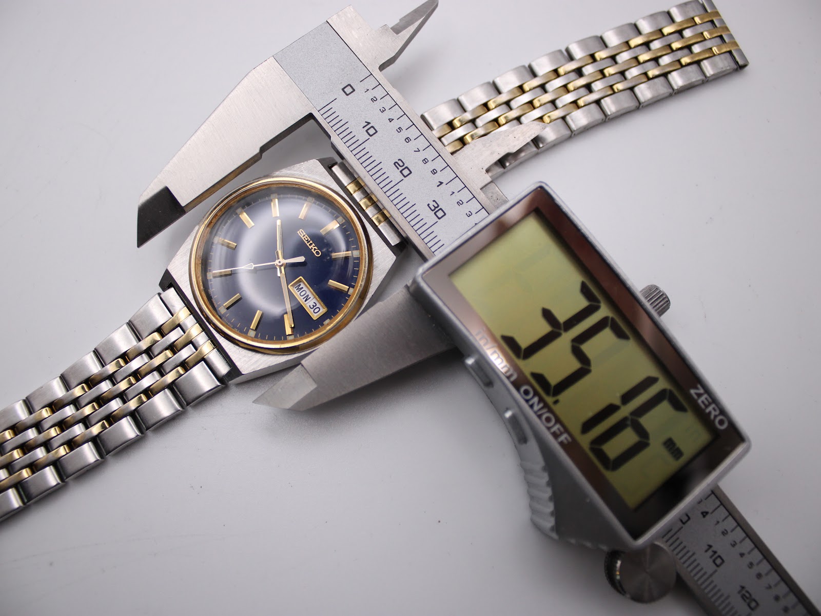 Digital caliper measuring the case diameter of the Seiko watch, displaying a precise 35.16mm.