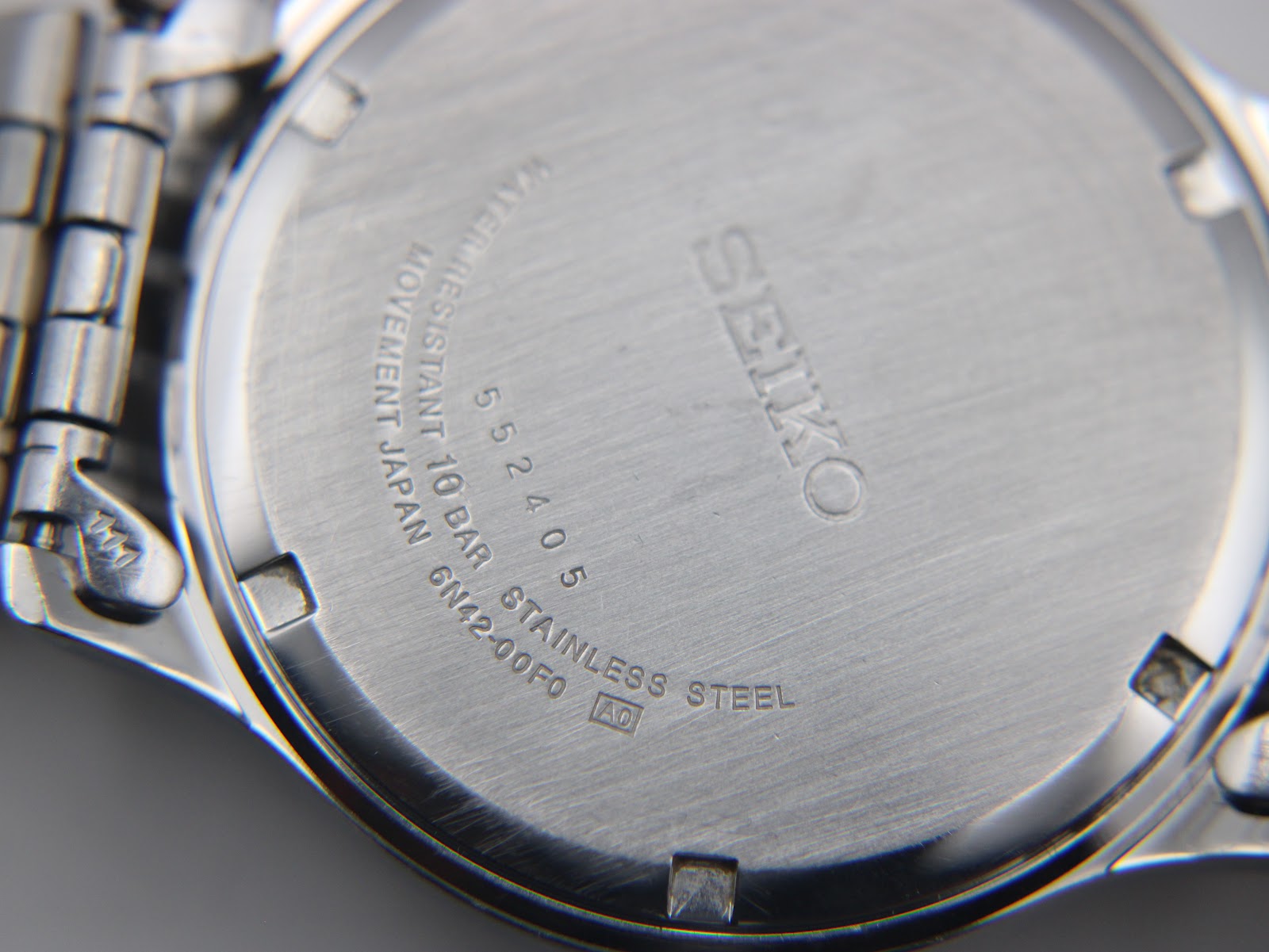 Rear view of the Seiko watch revealing the stainless steel case back with model and serial numbers.