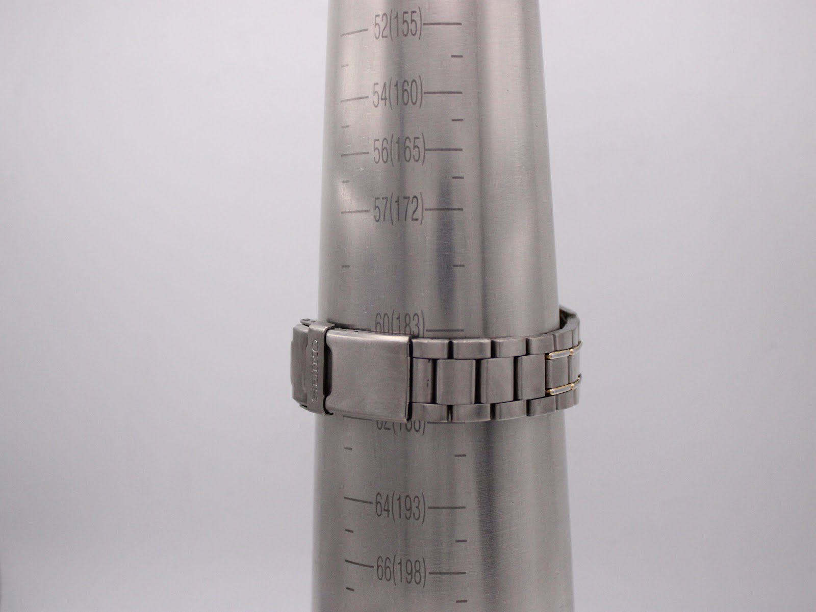 Seiko watch bracelet on a wrist sizing gauge, showing a wrist circumference of 180mm / 18cm.