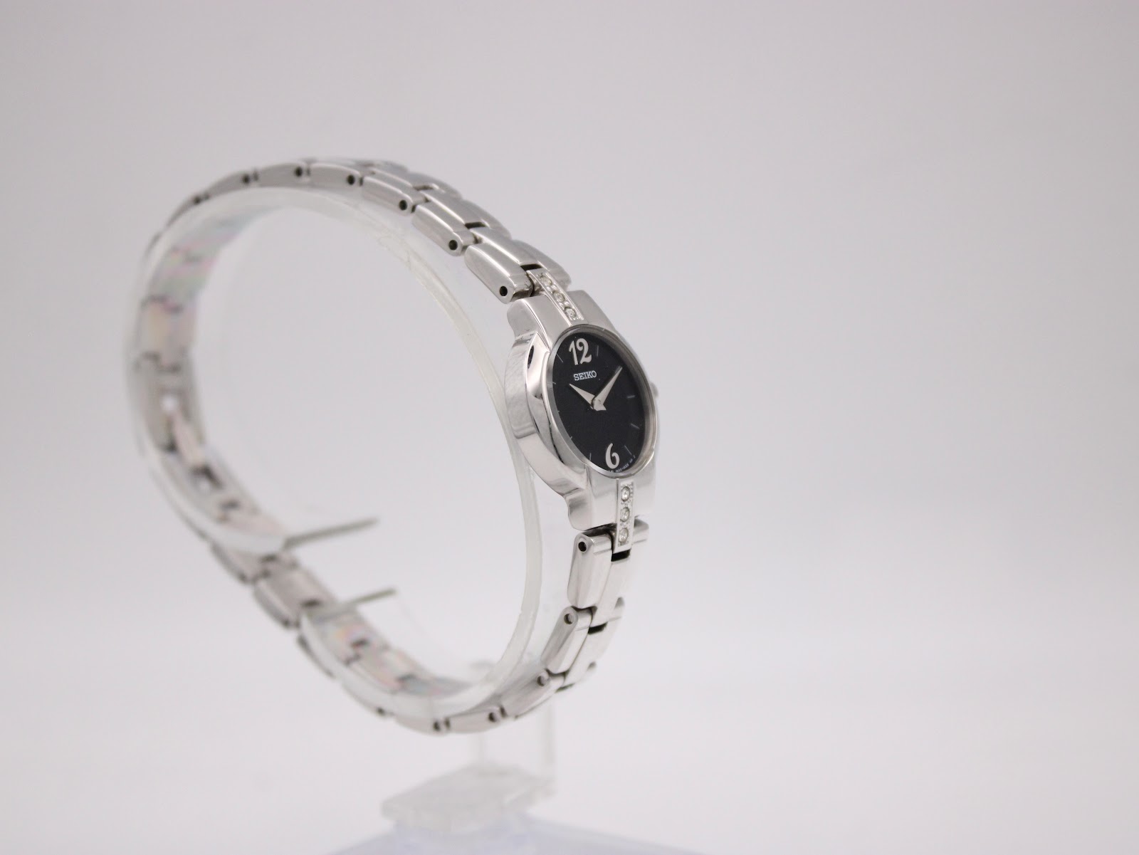 Another angled side view of the Seiko watch, showing the integrated steel bracelet and crystal details.