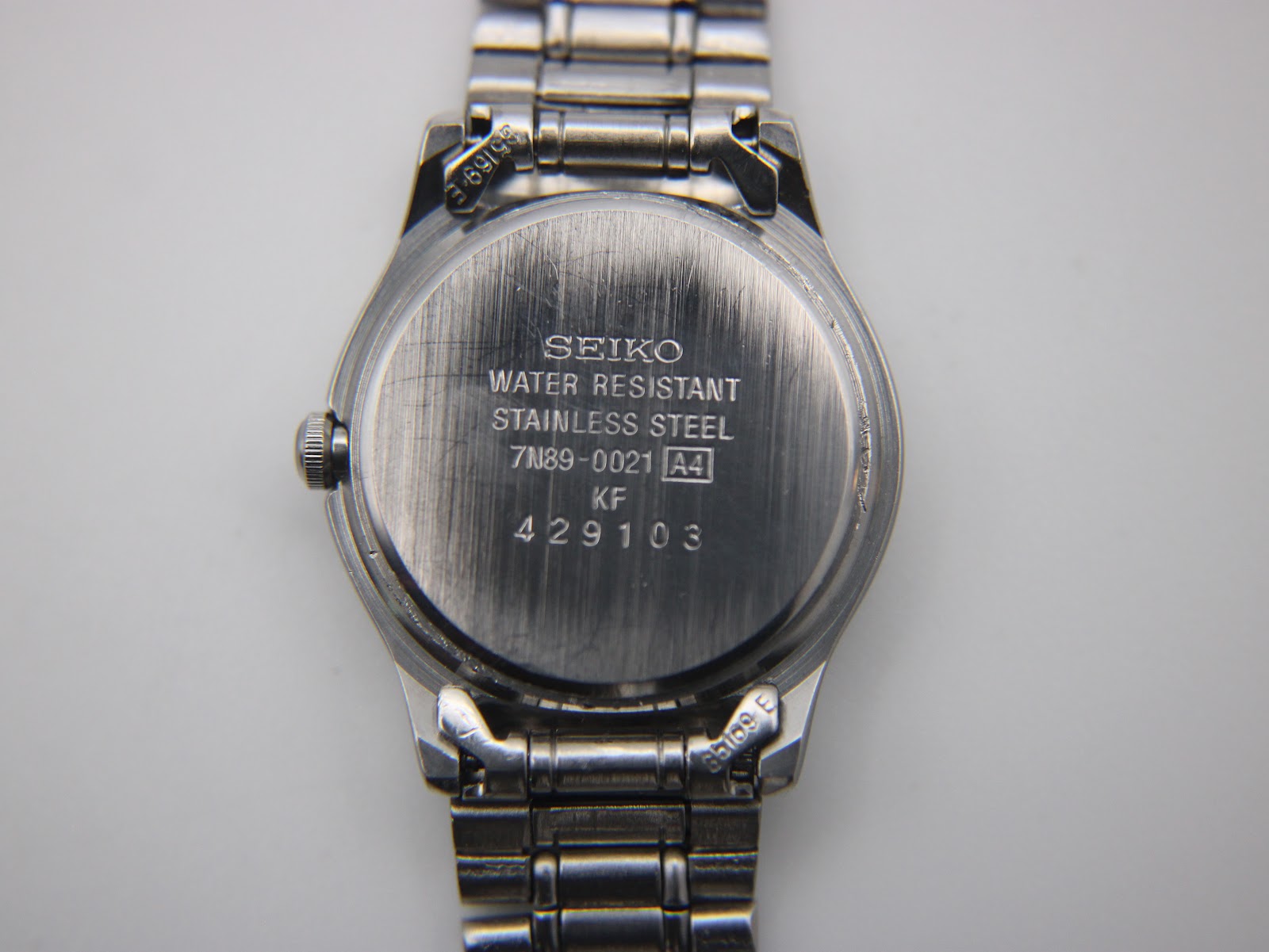 Rear view of the Seiko 7N89-0021 stainless steel case back with serial number details.