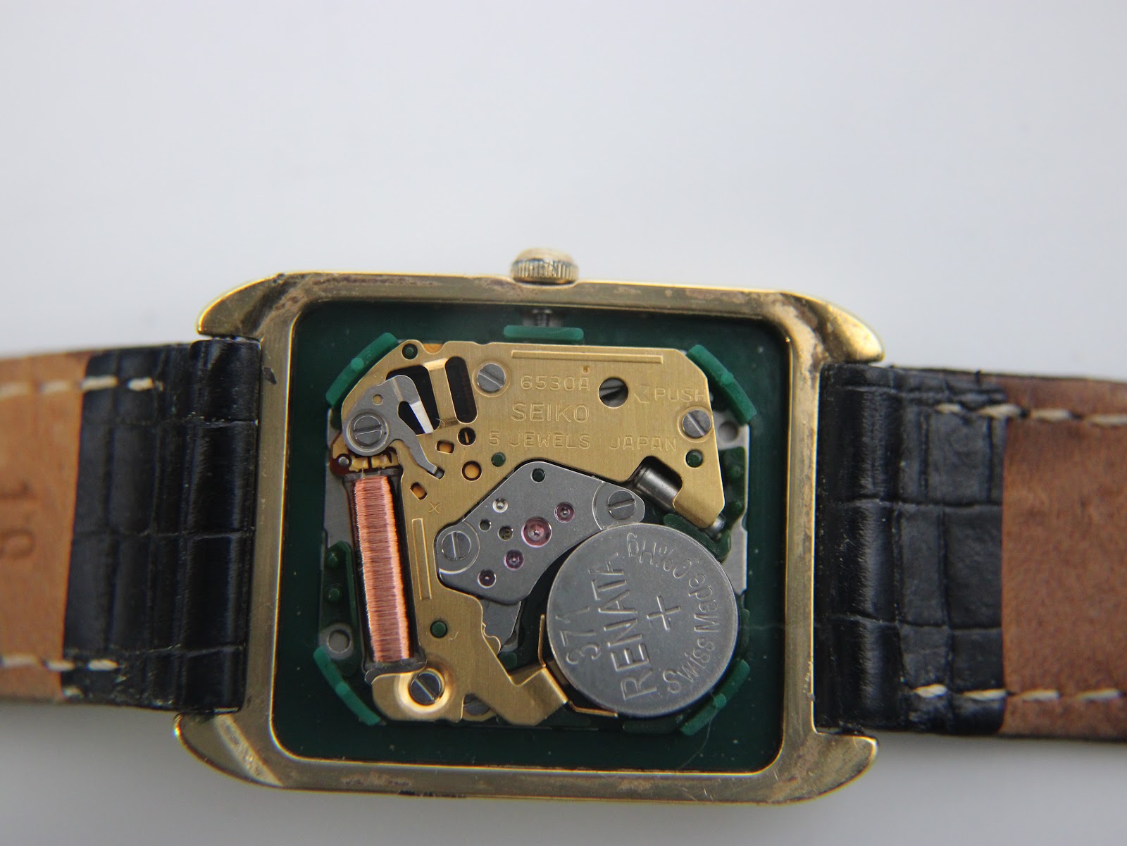 Rear view of the watch, showing the stainless steel case back with model and serial number engravings.