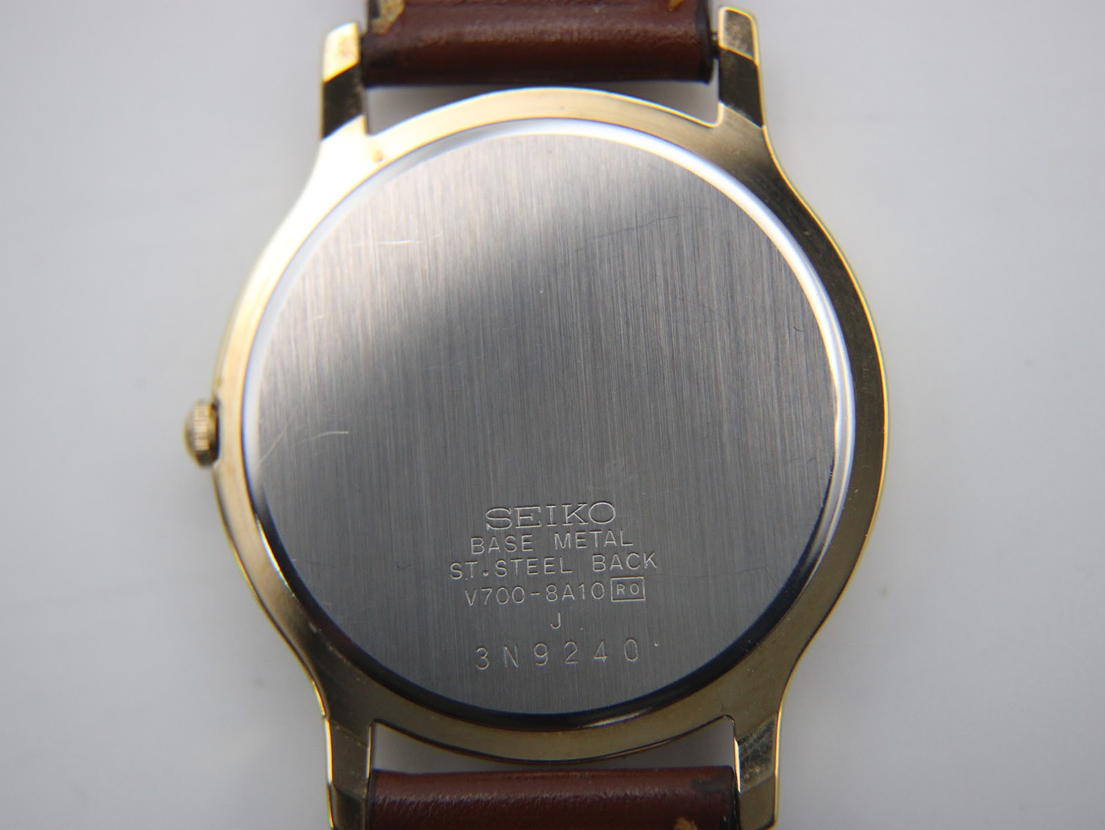 Detailed view of the dark brown leather strap, with its texture and stitching visible.