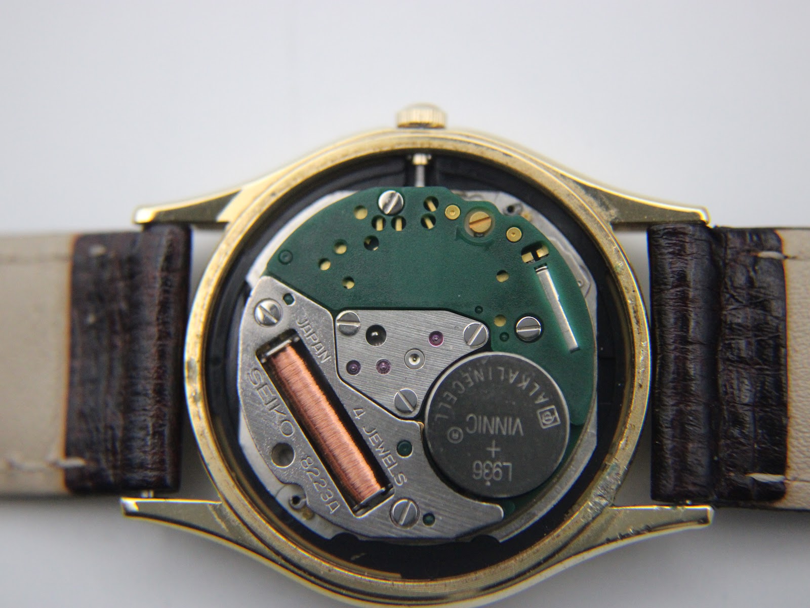 Detailed view of the Seiko 8223A quartz movement inside the watch, with battery and jewels visible.