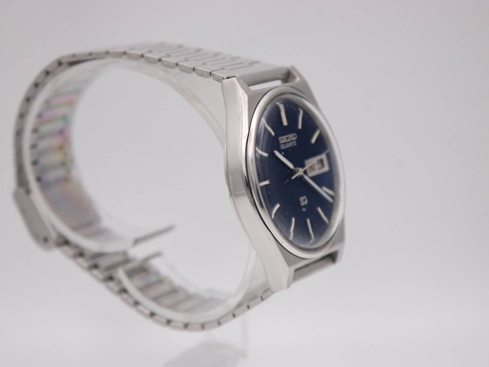 Another side angled view of the Seiko 7123-8430 watch, showing the brushed finish on the case and the bracelet's design.