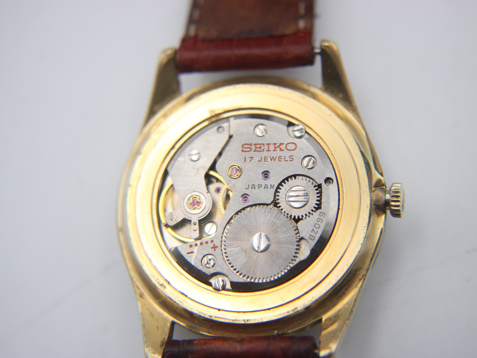 Open case back view revealing the Seiko 17 jewels hand-wind mechanical movement with 'JAPAN' and '6602B' markings.