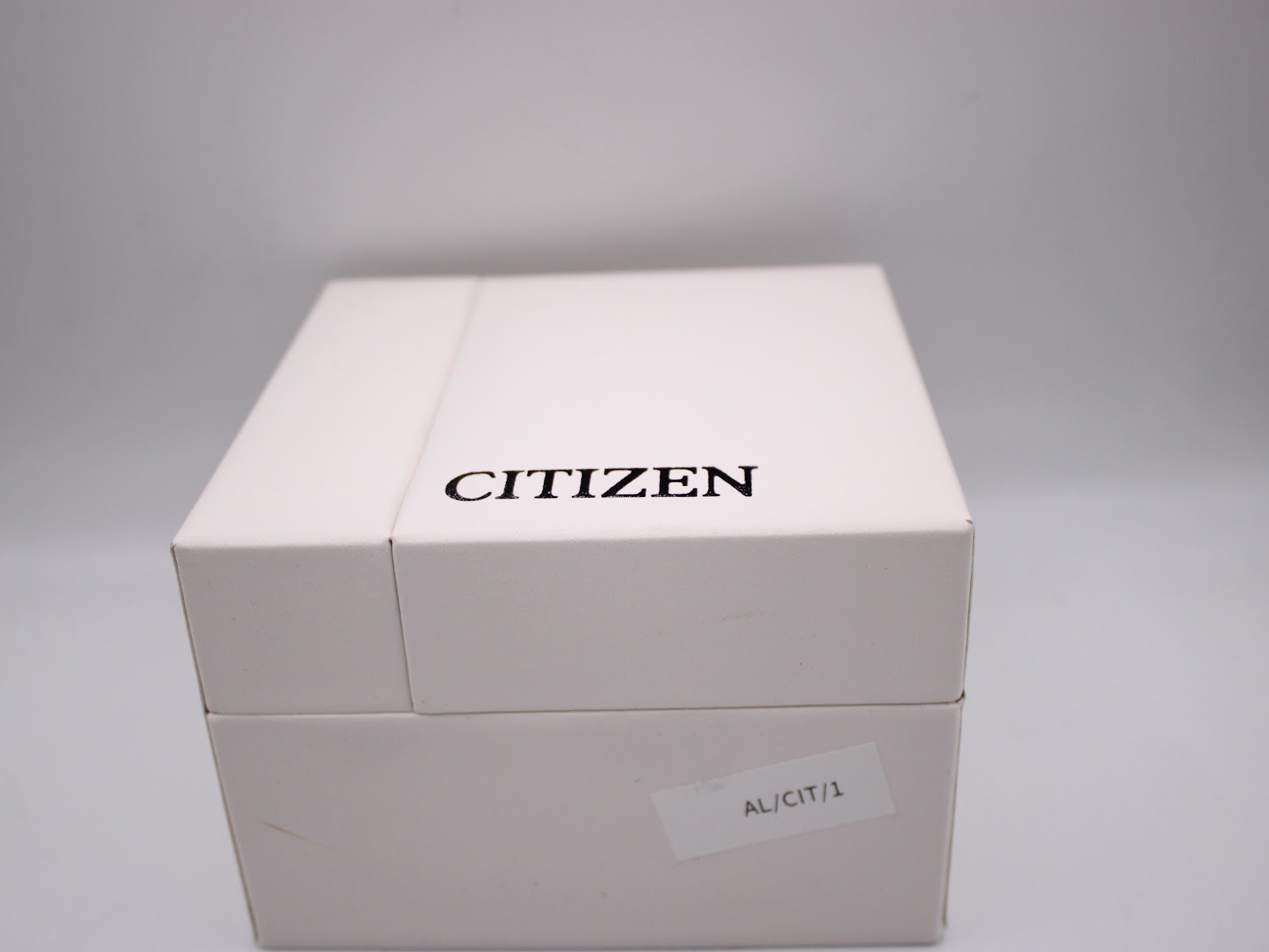 Exterior top view of the white original Citizen watch box with the brand logo.