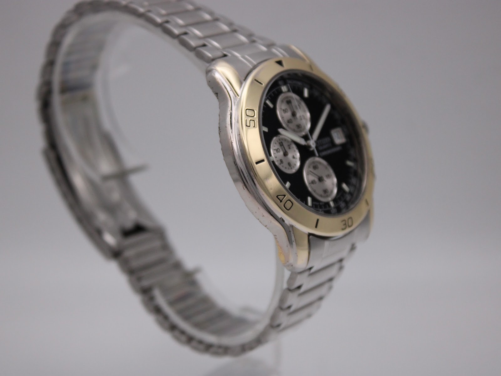 Close-up angled side view of the Citizen watch case and bezel, highlighting the two-tone finish.