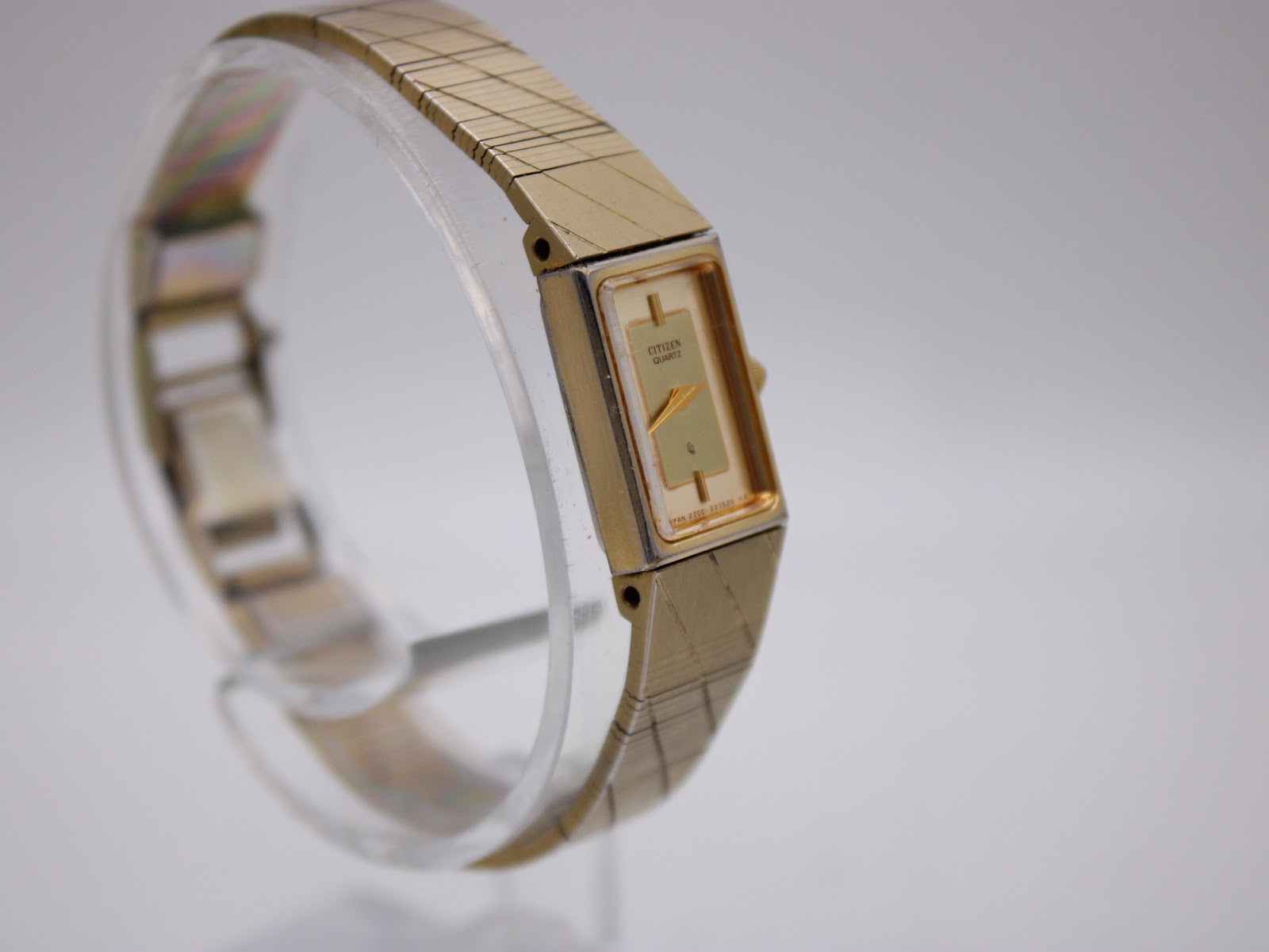 Another angled side view of the Citizen watch from a different perspective, highlighting the rectangular case and integrated bracelet.