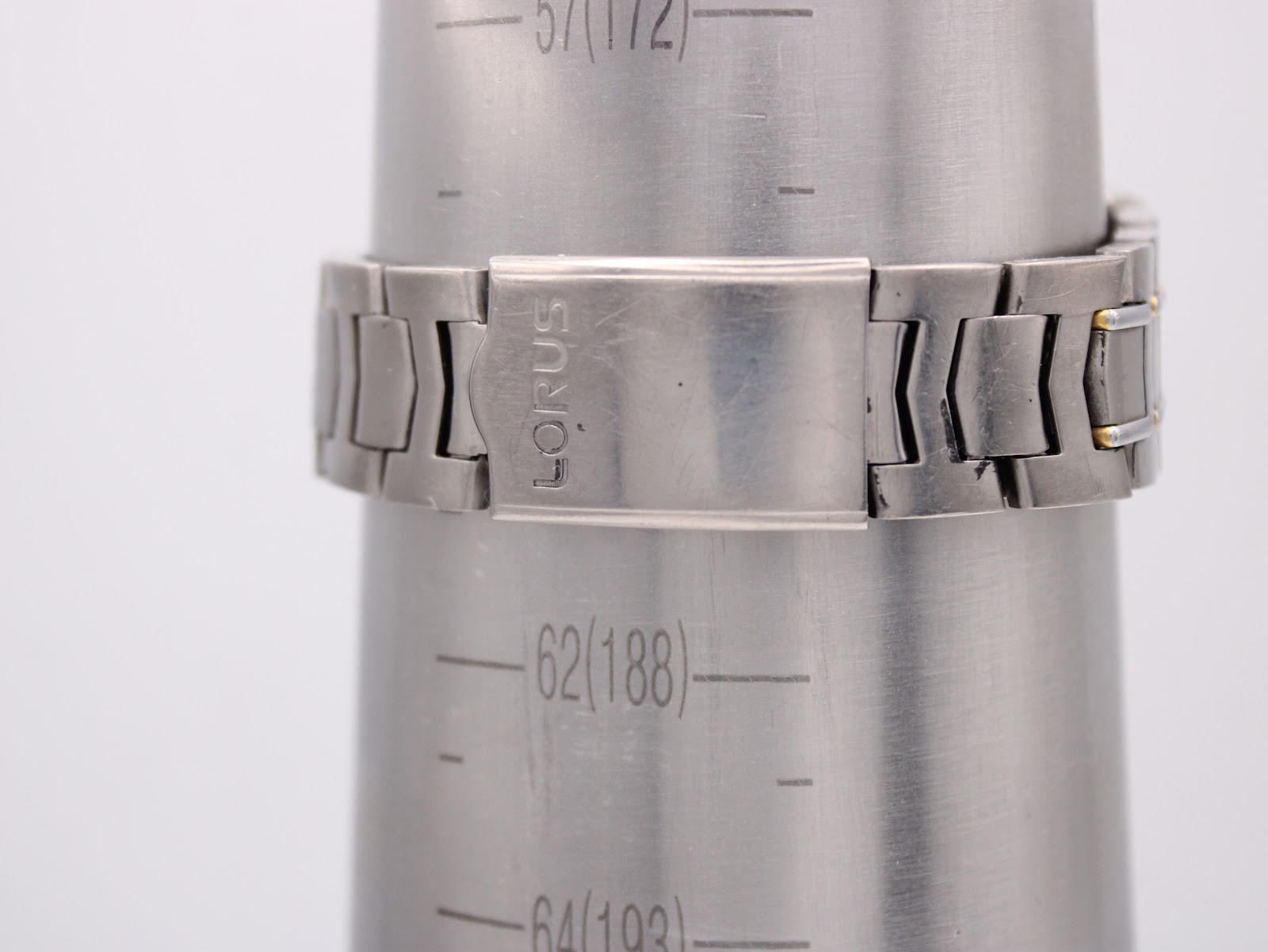 The Lorus two-tone titanium bracelet with its signed clasp, displayed on a wrist sizing gauge, indicating a wrist circumference of approximately 188mm.