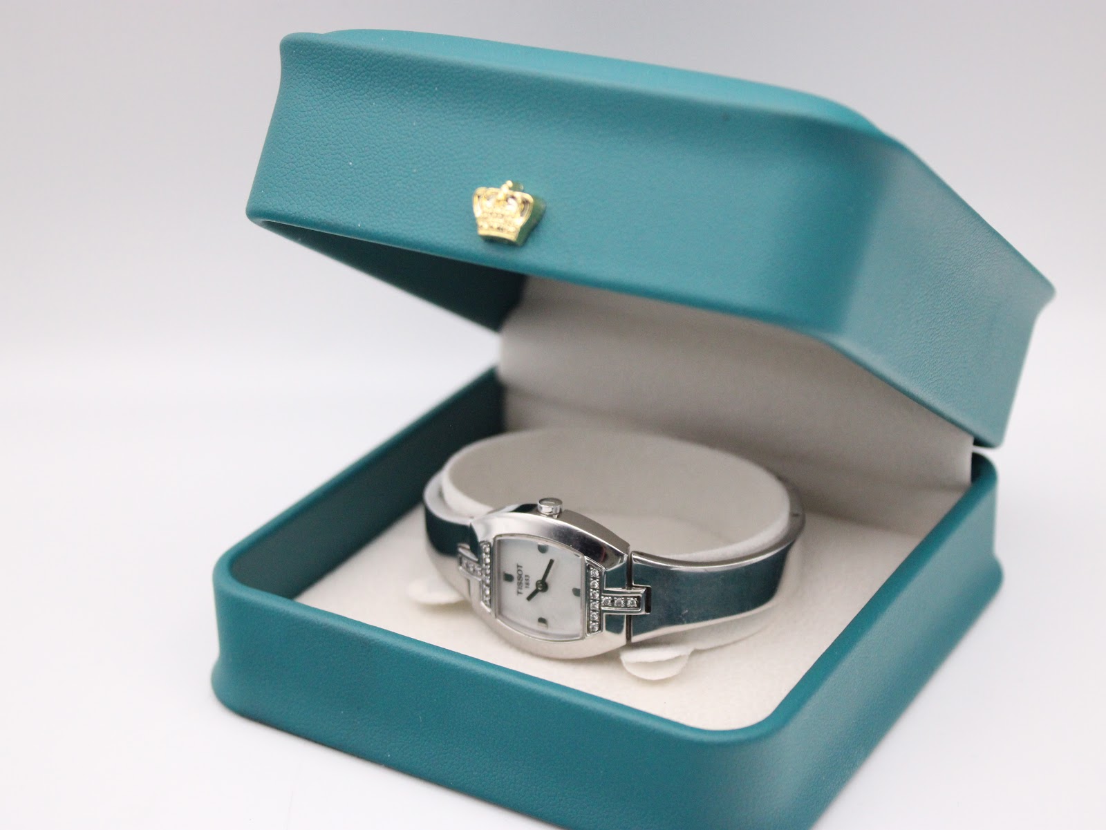 The Tissot L953 watch presented in its original teal-coloured box.
