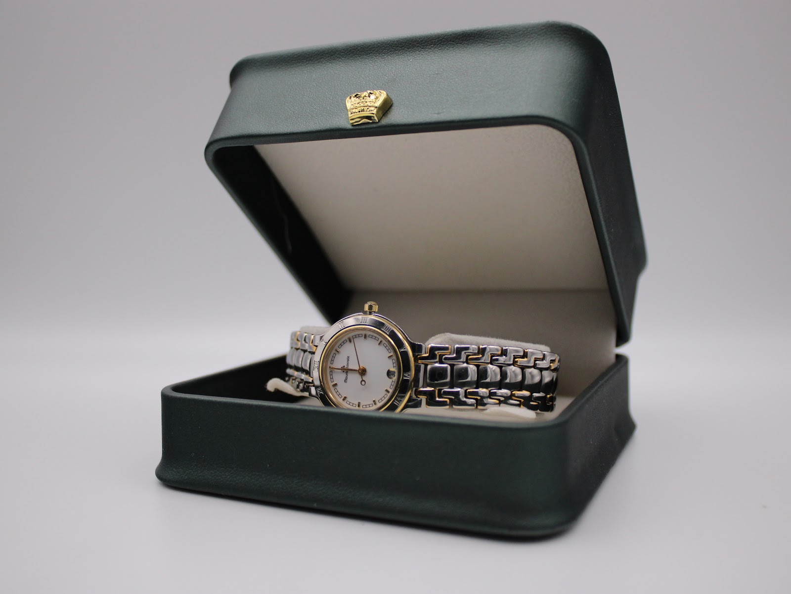 The Maurice Lacroix watch displayed in an open dark green presentation box.