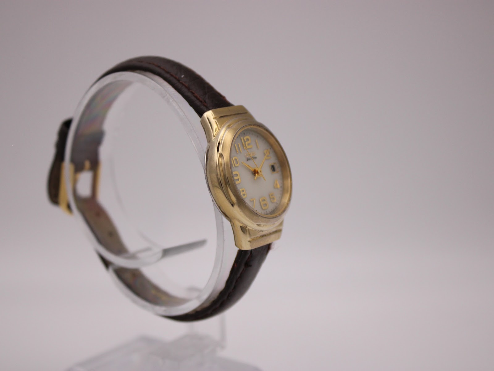 Other angled side view of the Citizen Eco-Drive watch on a display stand, showing the watch profile.