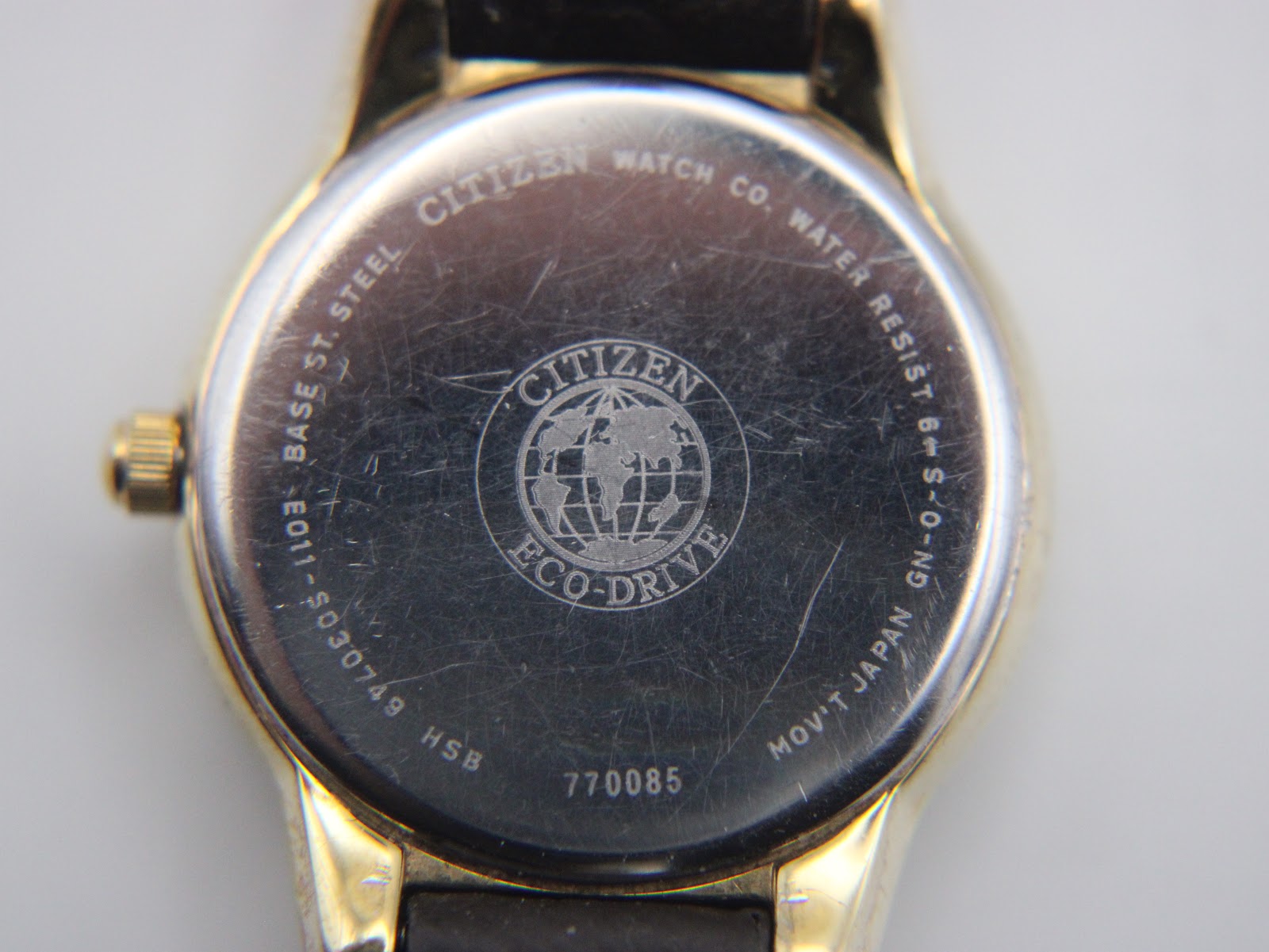 Close-up of the Citizen Eco-Drive case back, showing 'Citizen Eco-Drive', 'Base St. Steel', model S030749 and serial 770085.