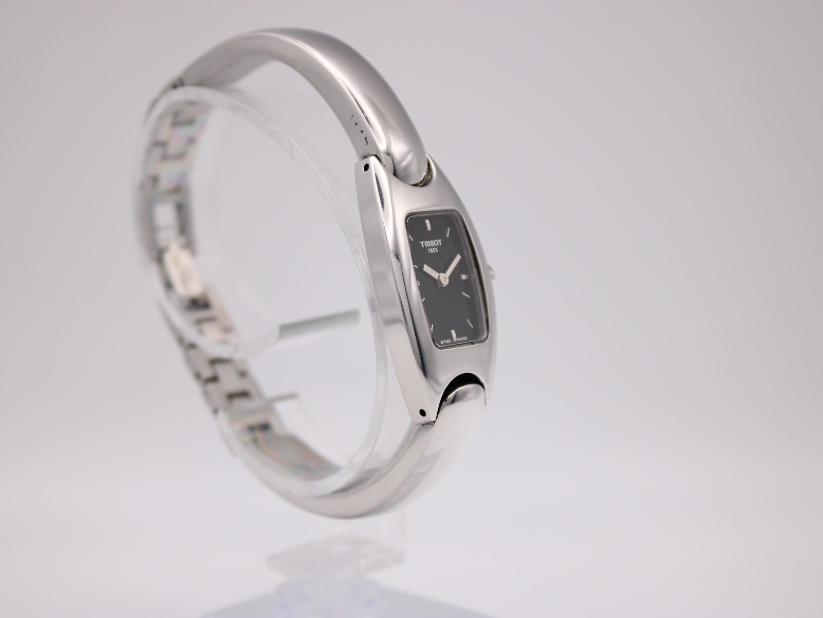 Angled side view of the Tissot G345 watch, highlighting the sleek profile of the case and integrated bracelet.