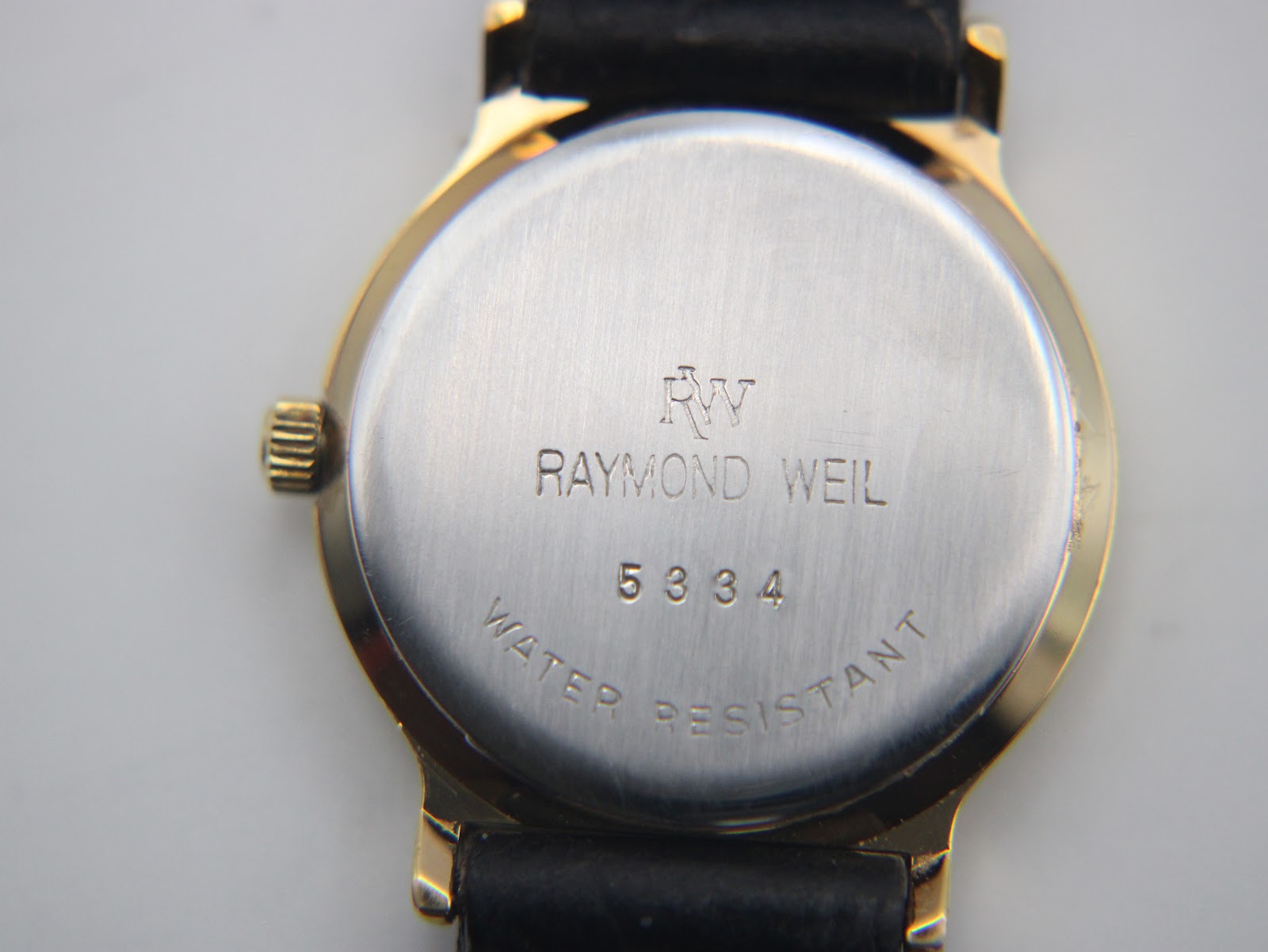 Close-up of the stainless steel case back with 'RAYMOND WEIL 5334 WATER RESISTANT' engraving.