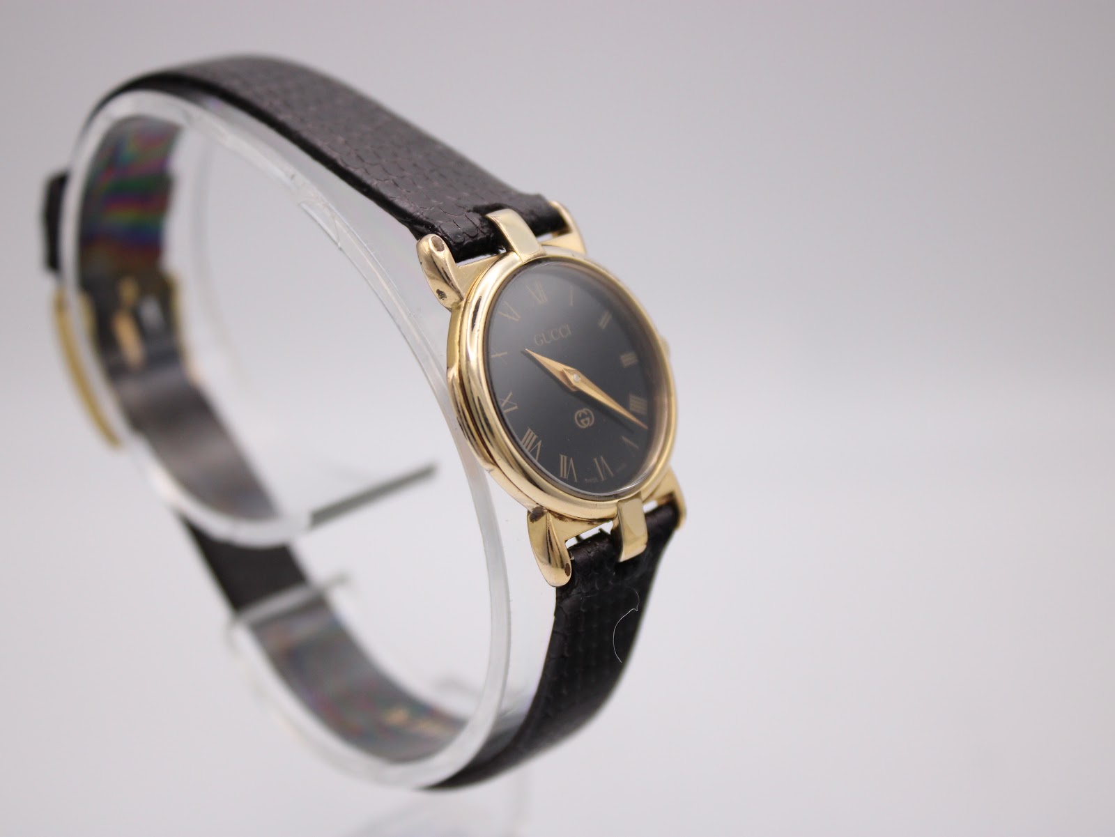 Another angled view of the Gucci 3400 L watch, highlighting the gold-tone case and black dial.
