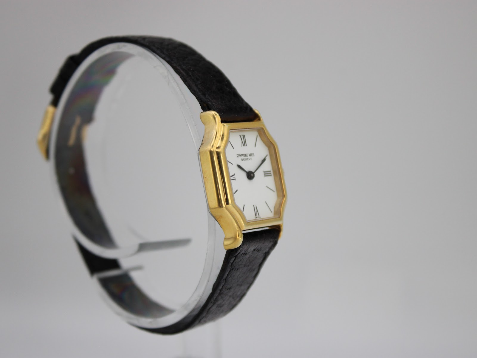 Opposite angled side view of the Raymond Weil 737 watch, showing the case shape and strap from another perspective.