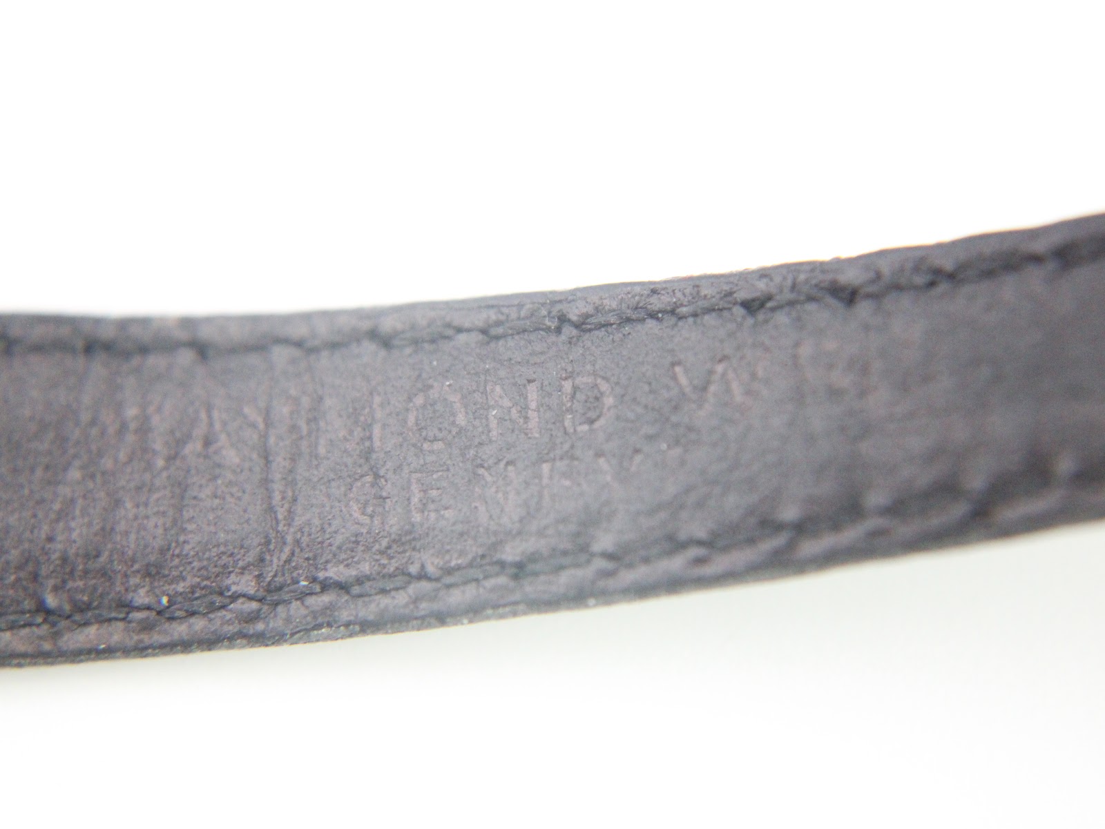 Detail photo of the watch strap's interior, showing the embossed 'RAYMOND WEIL GENEVE' text.