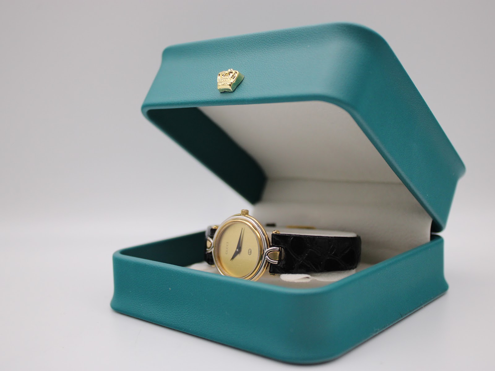 Gucci 4500 L watch presented in an open teal display box.