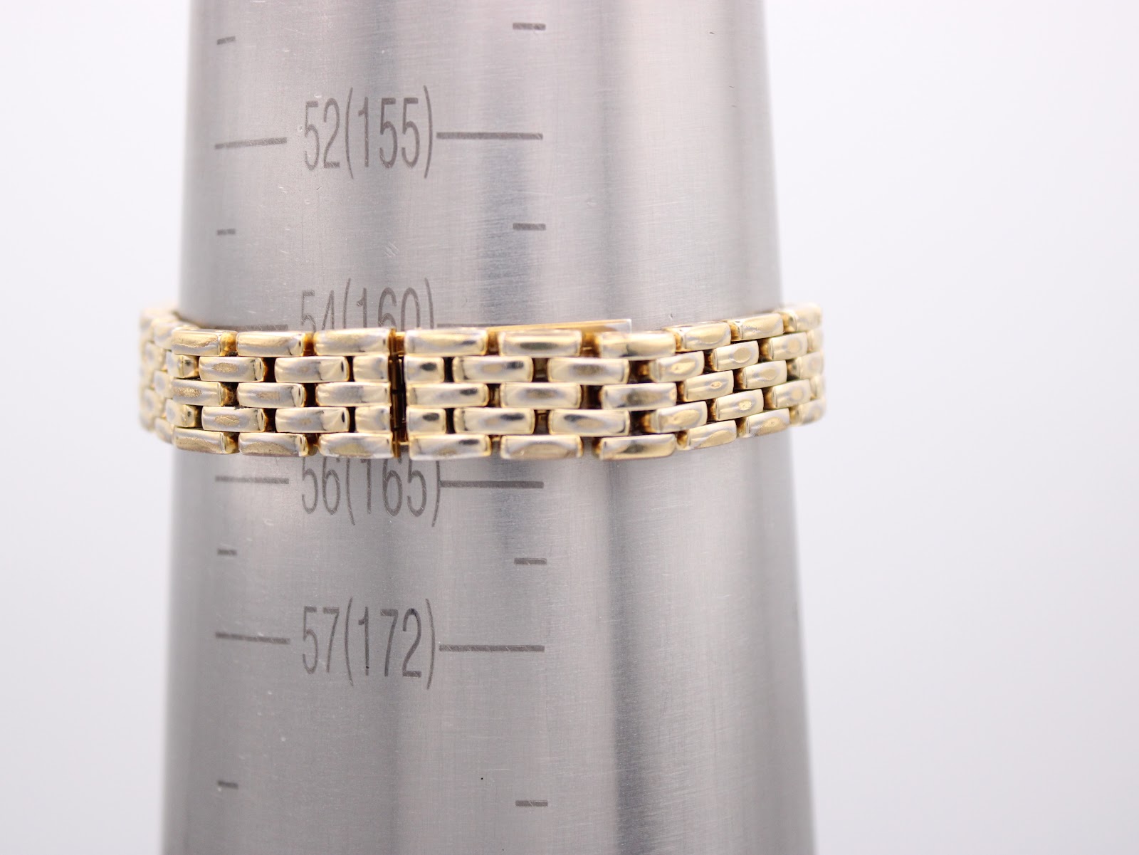 Close-up of the integrated gold-tone bracelet being measured on a wrist sizing cone, indicating a circumference of approximately 16.5cm or 165mm.
