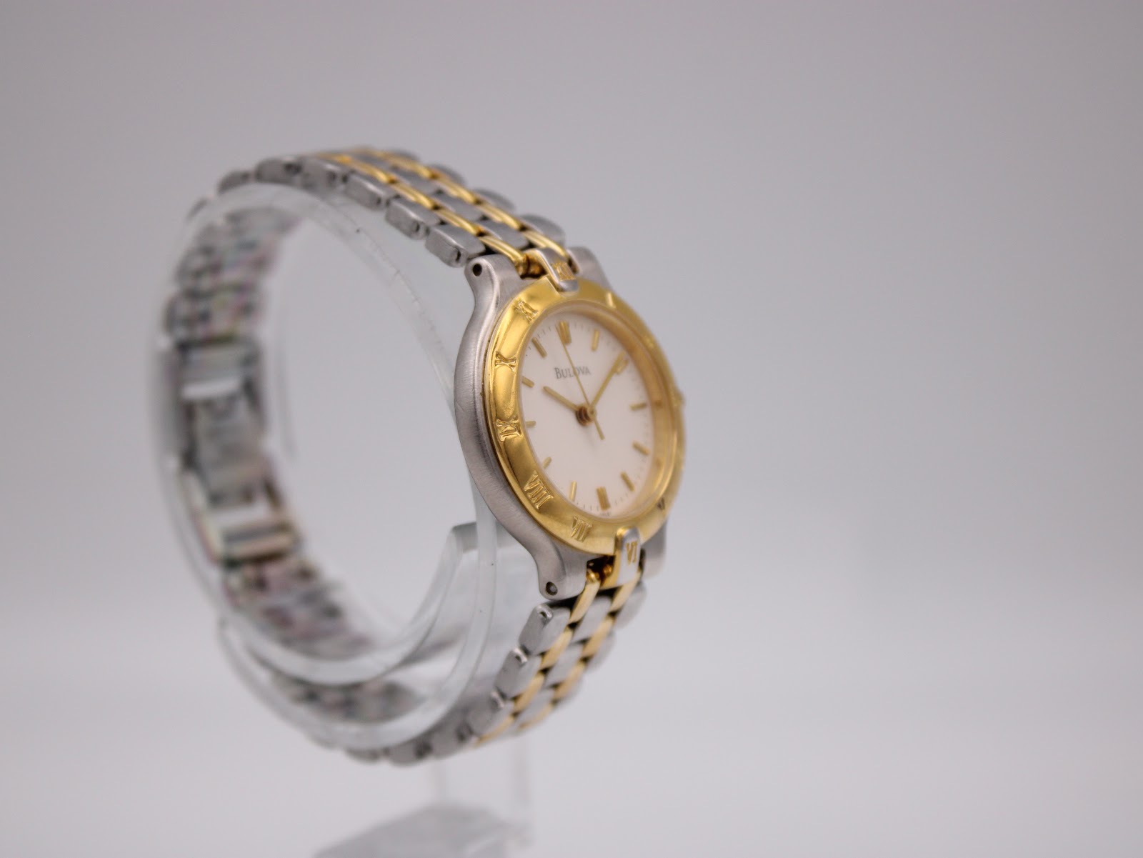Side view of the Bulova two-tone watch, highlighting the case profile and integrated bracelet.