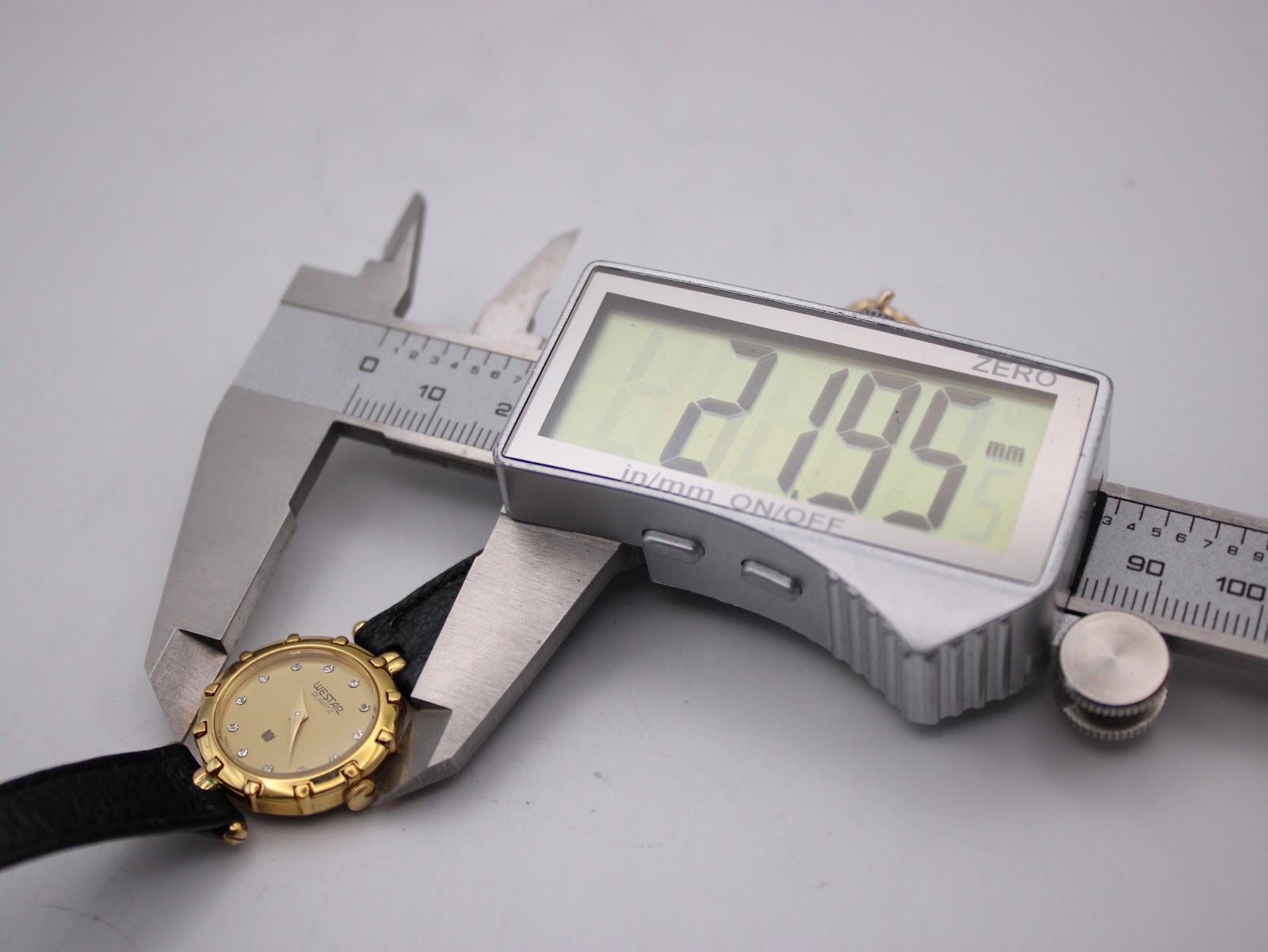 Digital caliper measuring the Westar watch case diameter at 21.95mm.