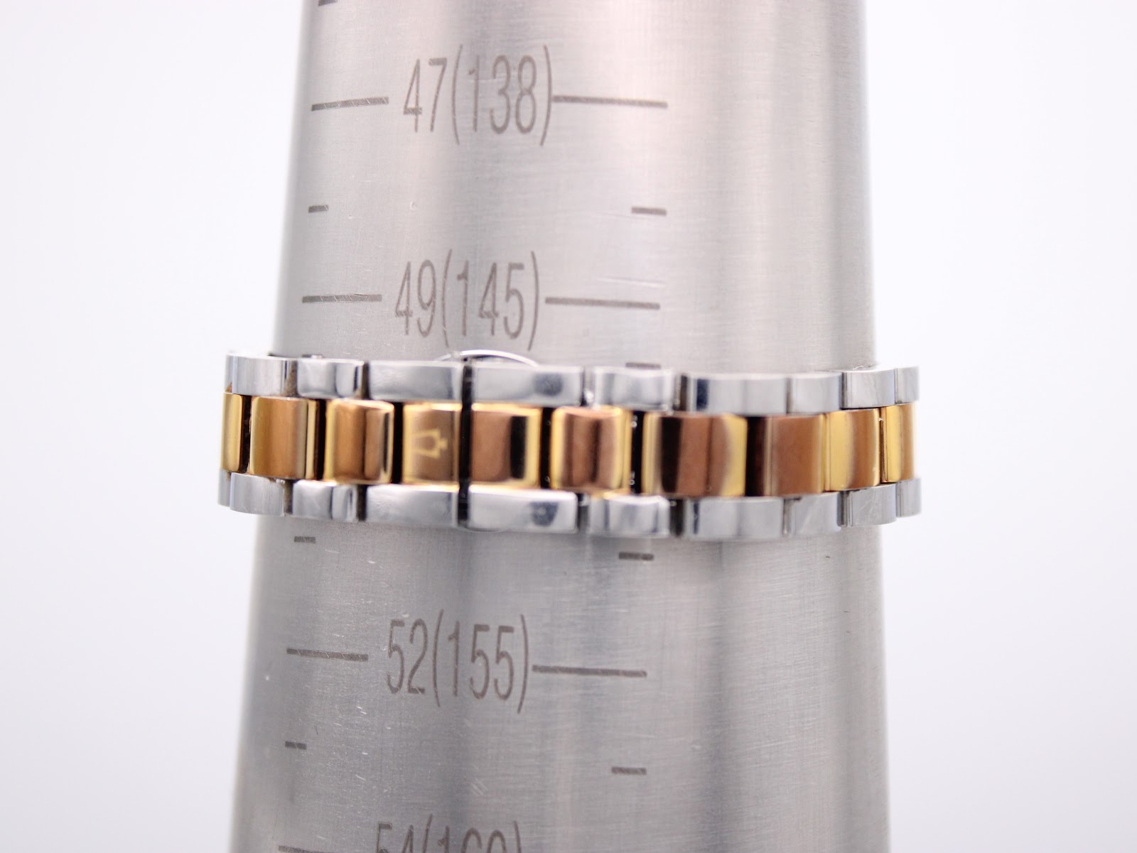 Watch bracelet on a wrist sizing gauge, indicating an approximate wrist circumference of 155mm.