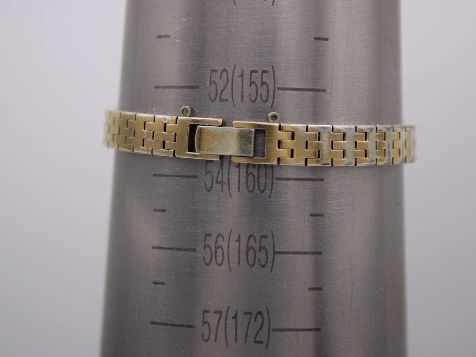 The watch bracelet clasped on a wrist sizing mandrel, showing a wrist circumference of approximately 158mm / 15.8cm.
