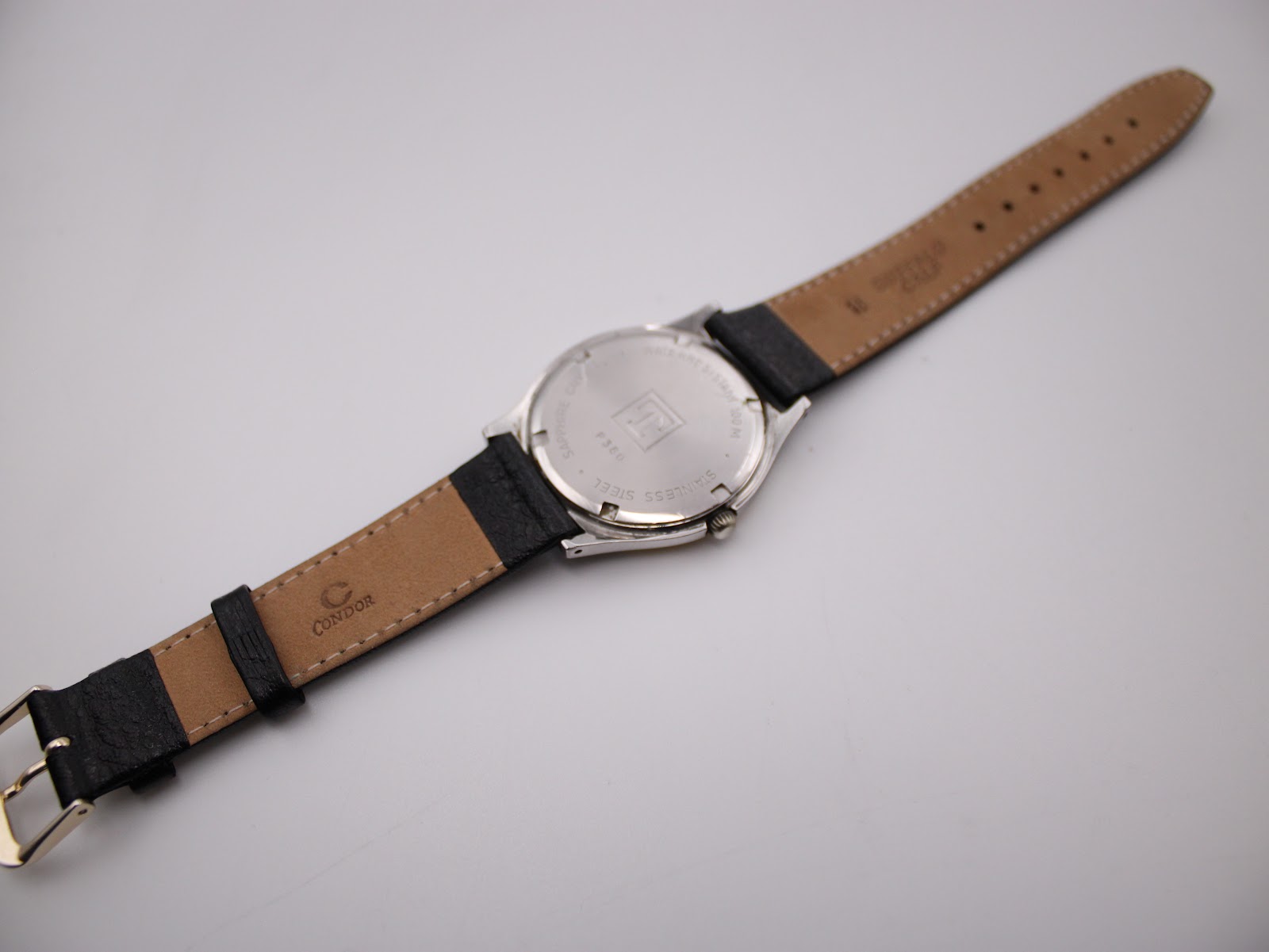 Back view of the Tissot PRX P380 showing the stainless steel case back and the reverse side of the replacement 'Condor' marked leather strap.
