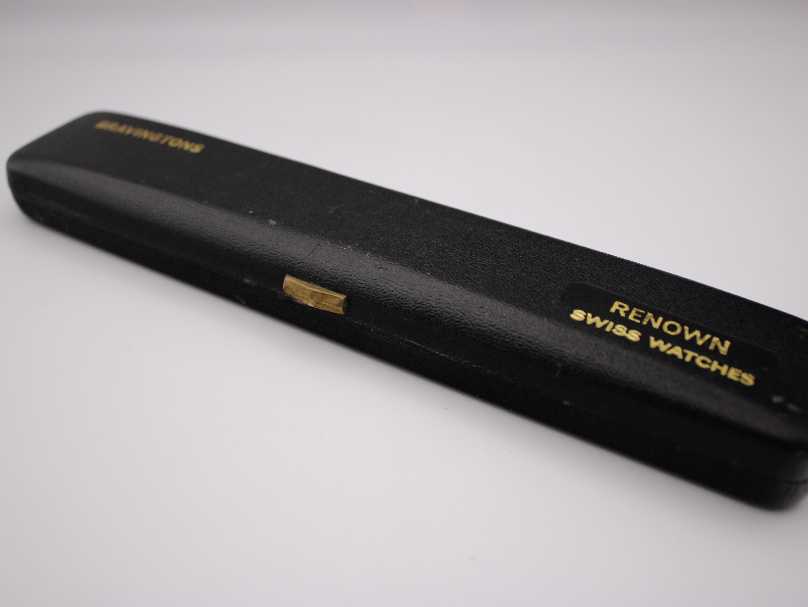 Closed generic black Bravingtons watch box with a 'Renown Swiss Watches' label on the side.