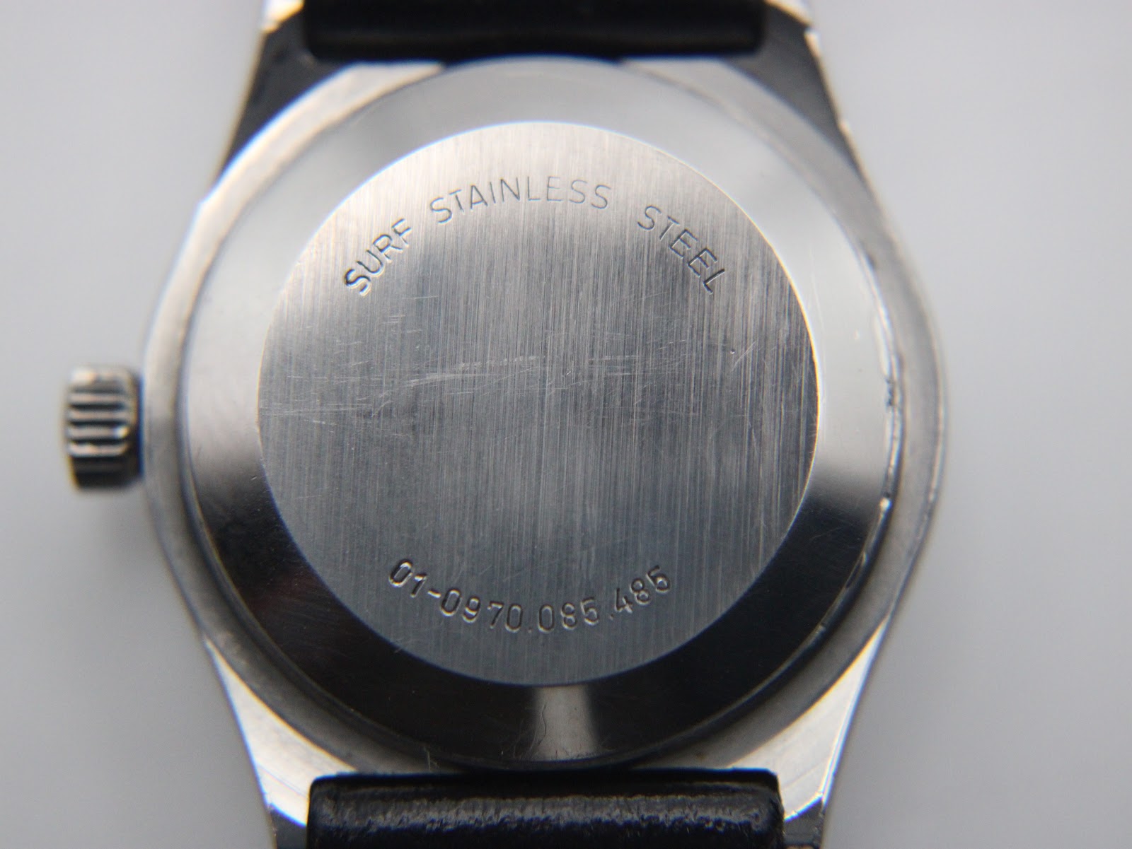 Close-up of the Zenith Espada stainless steel case back, showing 'Surf Stainless Steel' engraving and serial number.