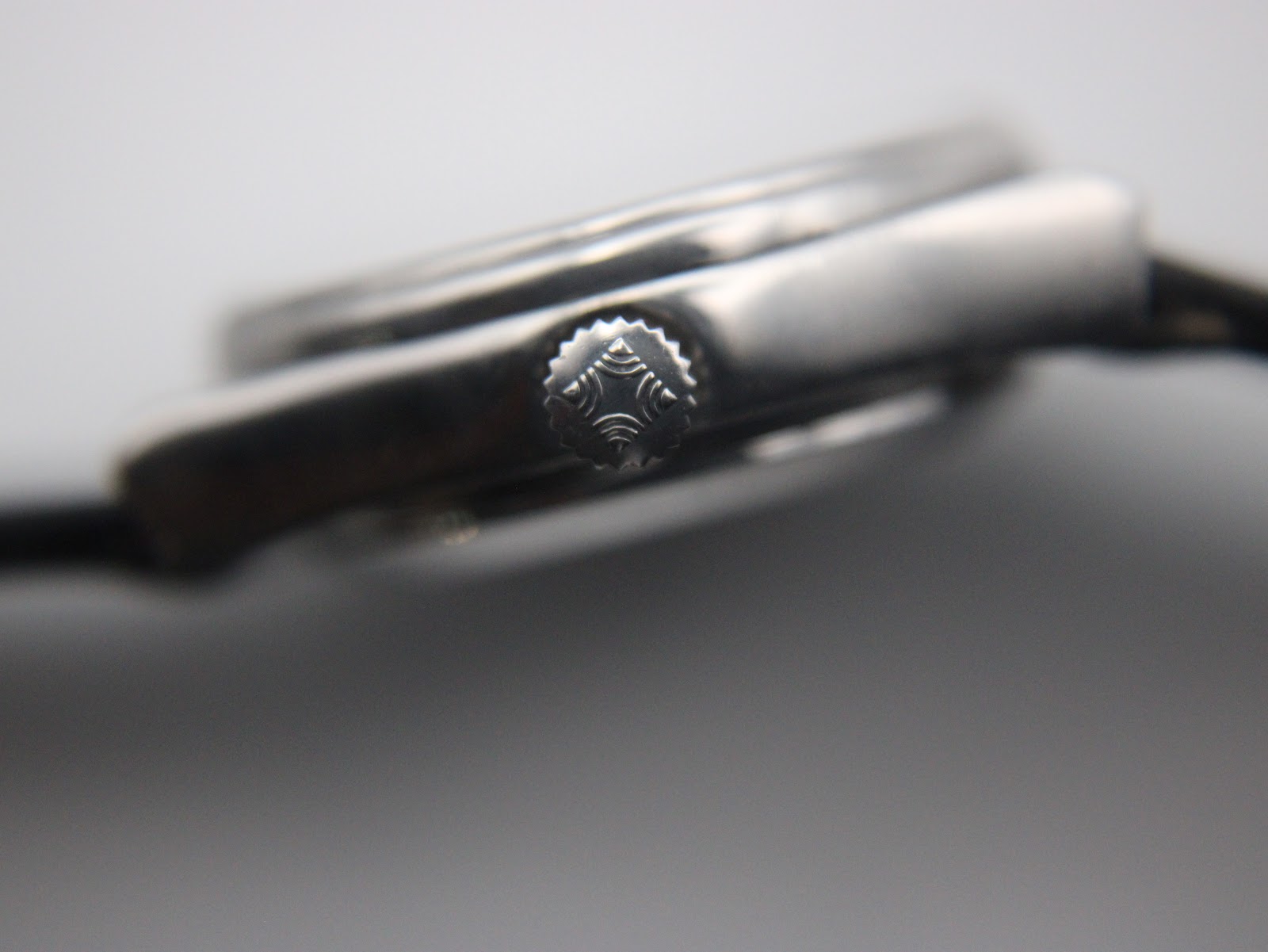 Extreme close-up of the Zenith Espada watch crown with an intricate embossed logo or pattern.