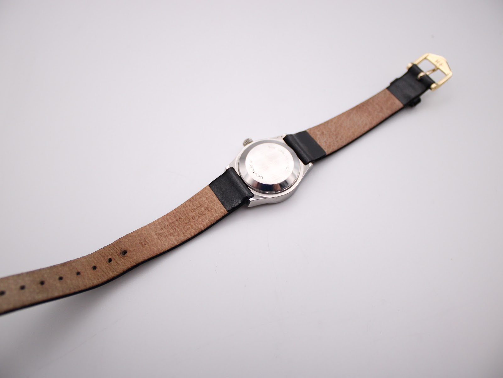 Back view of the Zenith Espada watch, showing the case back and the underside of the black leather strap with buckle.